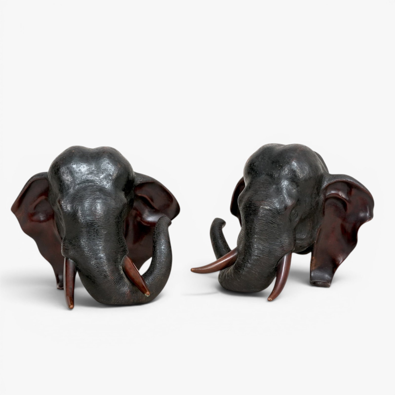 Japanese Bronze Elephant Head Bookends: Meiji Period, balancing on the trunk and ears, marked with three character mark of Genryusai Seiya The collection of Frank and Irene Giuffrida, owners of the famous Hilltop Steakhouse, Saugus, MA