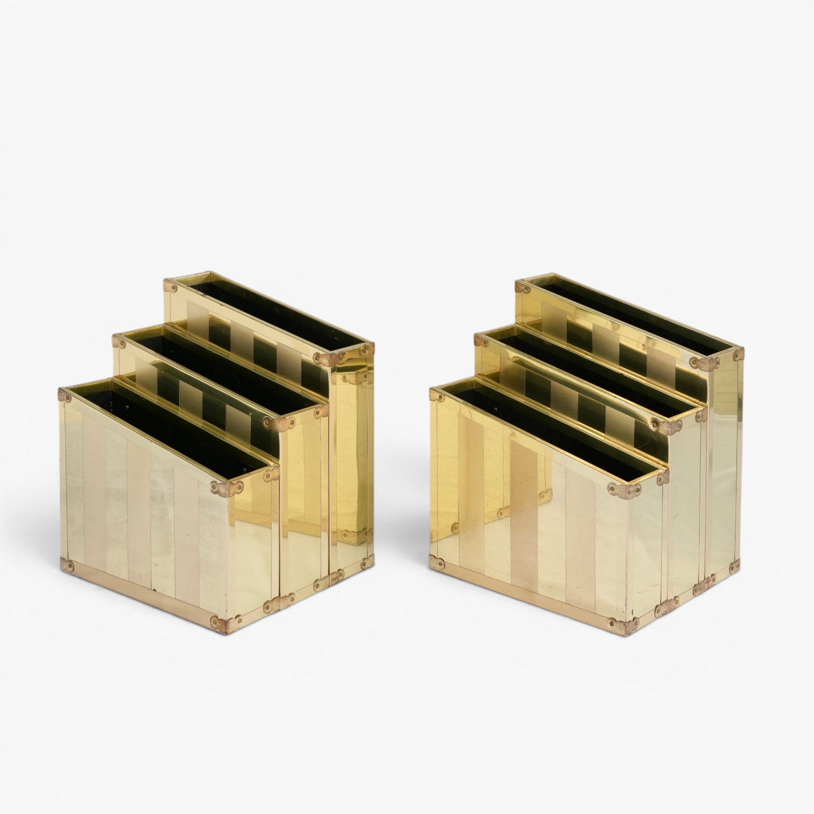 A Pair of Vintage Brass Three Tier Magazine Racks, 1970's: Mid century modern aesthetic, unlabeled and attributed to Serried Ltd., with three tiered compartments, vertical striping The collection of Frank and Irene Giuffrida, owners of the famous Hilltop