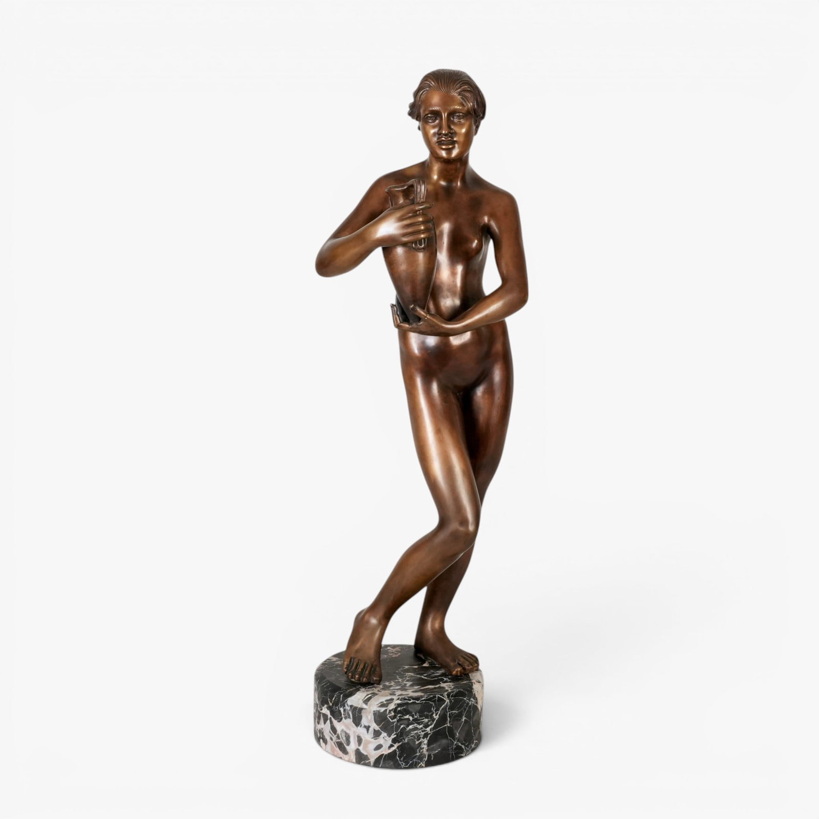 Italian Bronze Nude holding a Vase: The neoclassical style female nude holding a vase posed on a black marble base with lighter striations, bronze with deep brown patina, vase rim signed "Gemito" (after Vincenzo Gemito, 1852-1929) The c