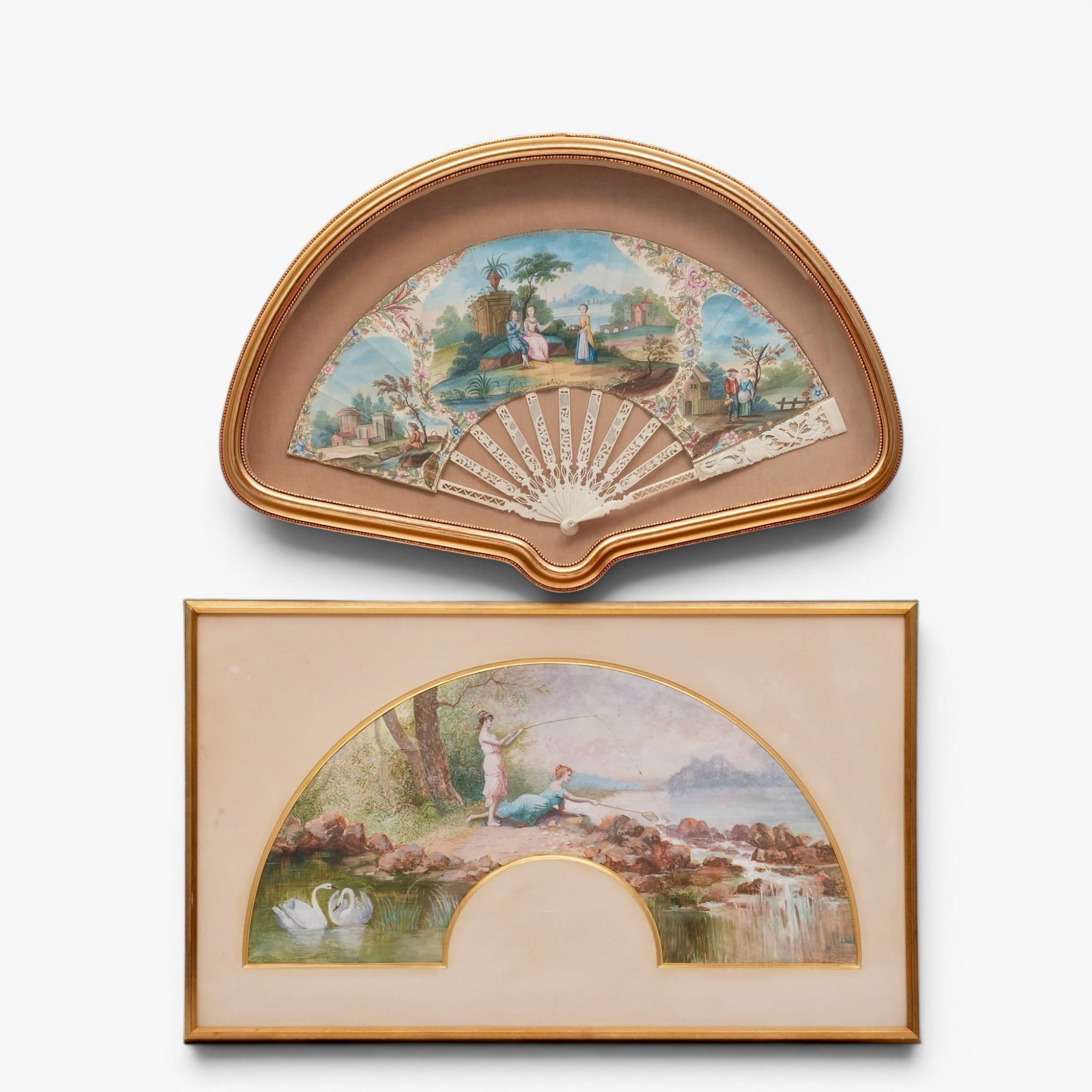 Two European Framed Hand Painted Folding Fans: late 19th century, painted on paper with cartouches of figures in gentile country settings separated by a foliate meander with gilt highlights, mounted on carved and pierced bone sticks, framed in a s