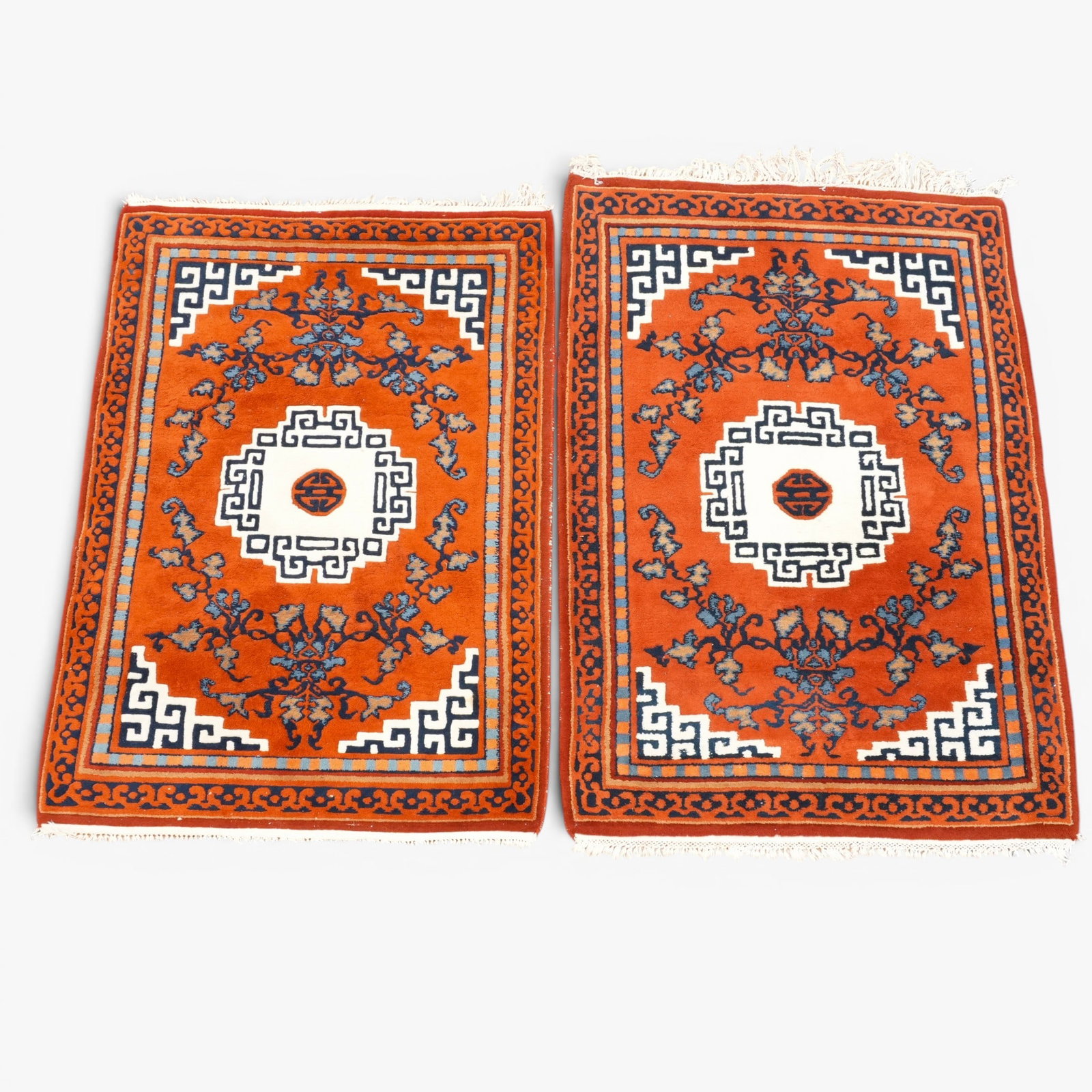 Pair of Modern Chinese Style Carpets: Each with squared scrolling and stylized foliate patterns, dark blue, beige and white on a rust field The collection of Frank and Irene Giuffrida, owners of the famous Hilltop Steakhouse, Saugus, MA