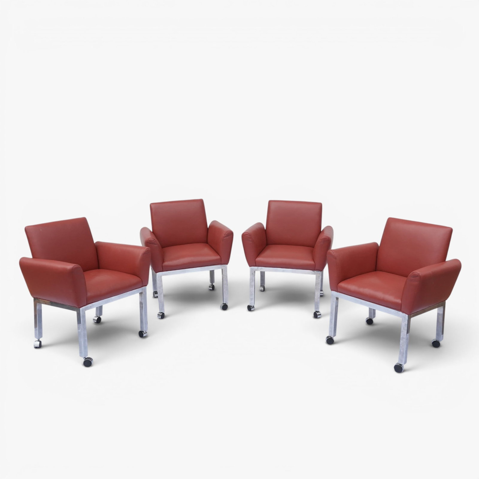 Four 1970's Lounge Chairs Attributed to TriMark Designs: Split side armchairs in soft faux leather upholstery, chrome metal base and caster feet The collection of Frank and Irene Giuffrida, owners of the famous Hilltop Steakhouse, Saugus, MA
