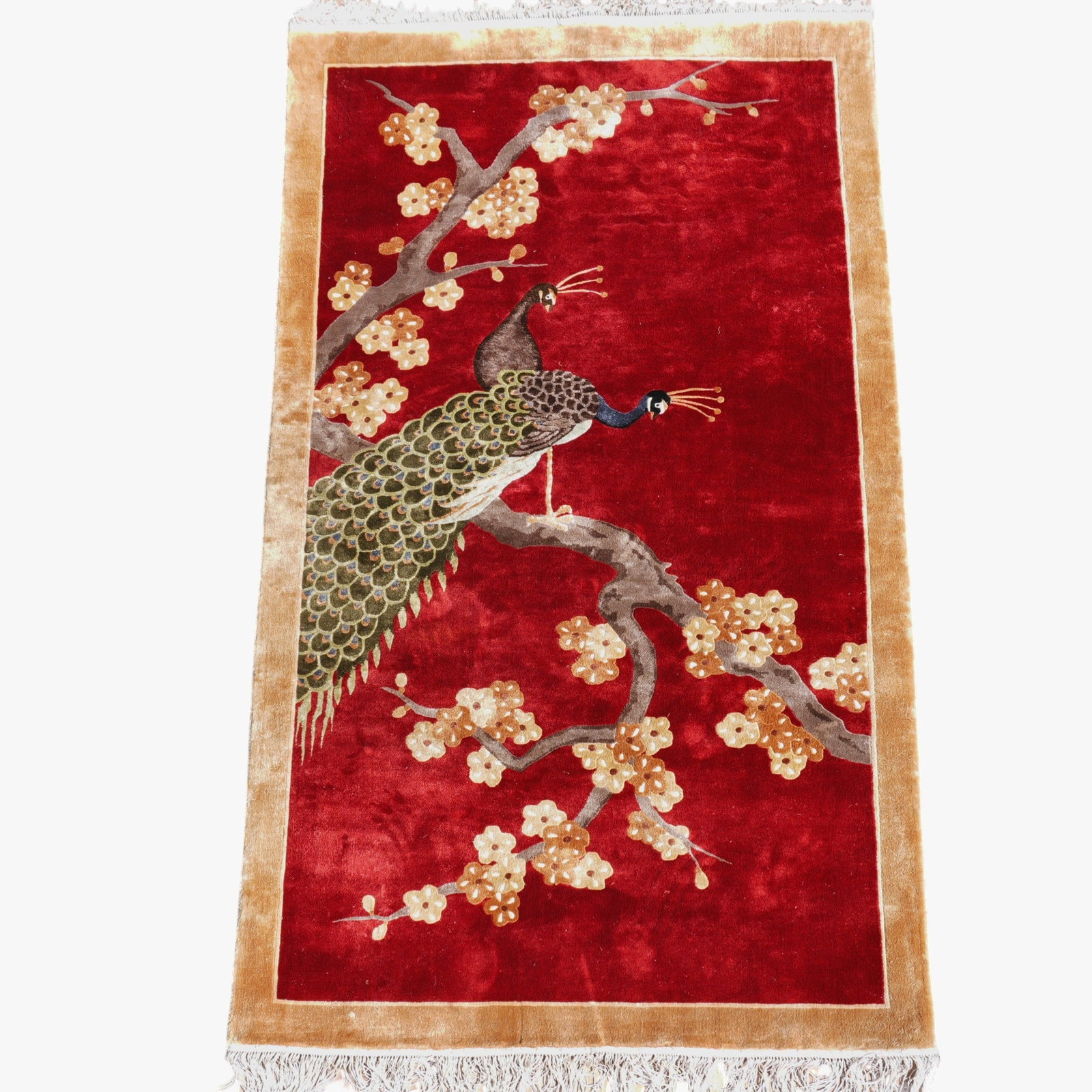 Chinese Silk Carpet with Peacock Design: 20th century, two peacocks on the branch of a blossoming prunus tree on a deep red field The collection of Frank and Irene Giuffrida, owners of the famous Hilltop Steakhouse, Saugus, MA