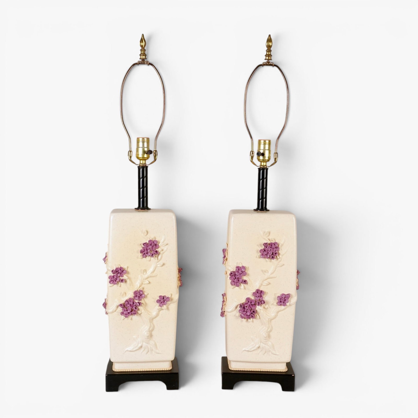 Pair of Ceramic Lamps: 20th century, of rectangular shape, three sides decorated in relief with an Asian style gnarled prunus tree with purple flowers in full bloom, the body glazed in a soft white with darker flecking, woo