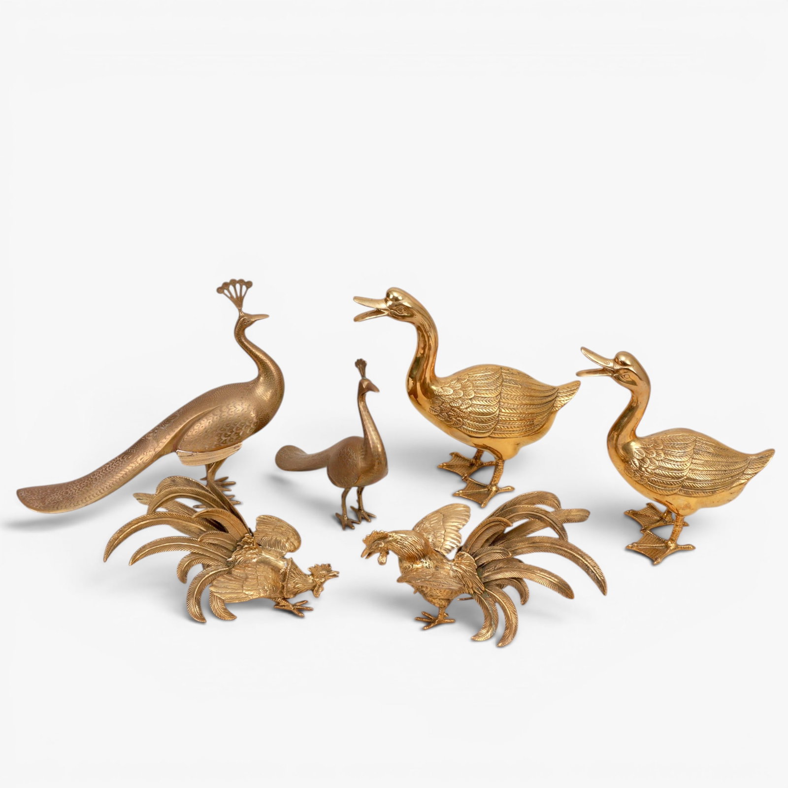 Group of Six Brass Birds: 20th century, comprising: two peacocks, two ducks, two fighting cocks The collection of Frank and Irene Giuffrida, owners of the famous Hilltop Steakhouse, Saugus, MA