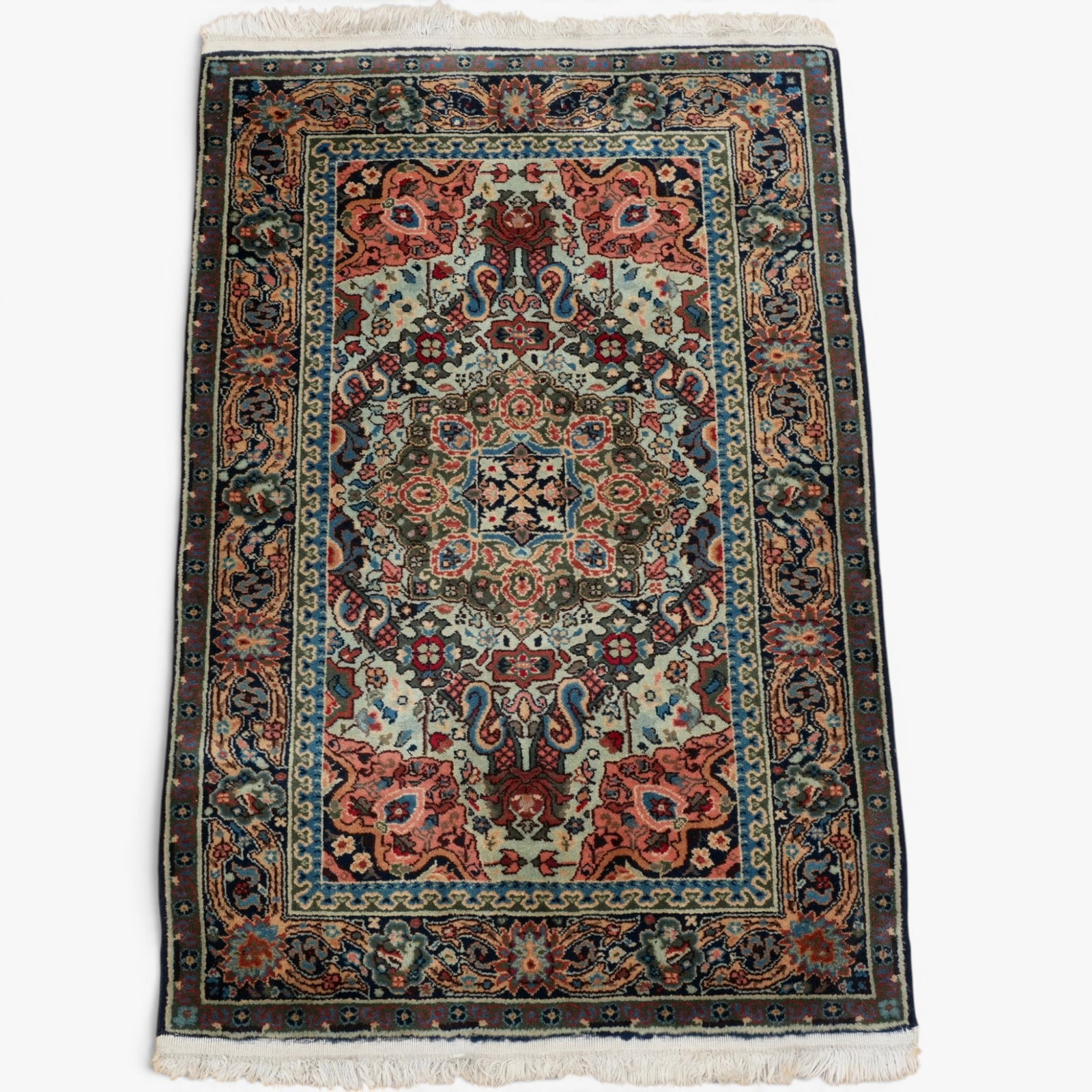 A Persian Tabriz Rug: Hand knotted with a dense foliate design in salmon and celadon greenThe collection of Frank and Irene Giuffrida, owners of the famous Hilltop Steakhouse, Saugus, MA