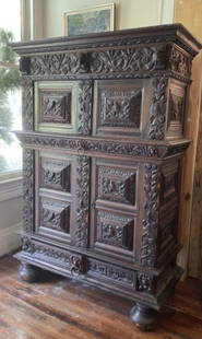 Amazing 17th century or earlier baroque French? Carved cabinet chest: Profusely carved throughout. Returning its original locking mechanism. This incredible cabinet is likely French dating from the 17th century or earlier. The top section opens but the bottom section