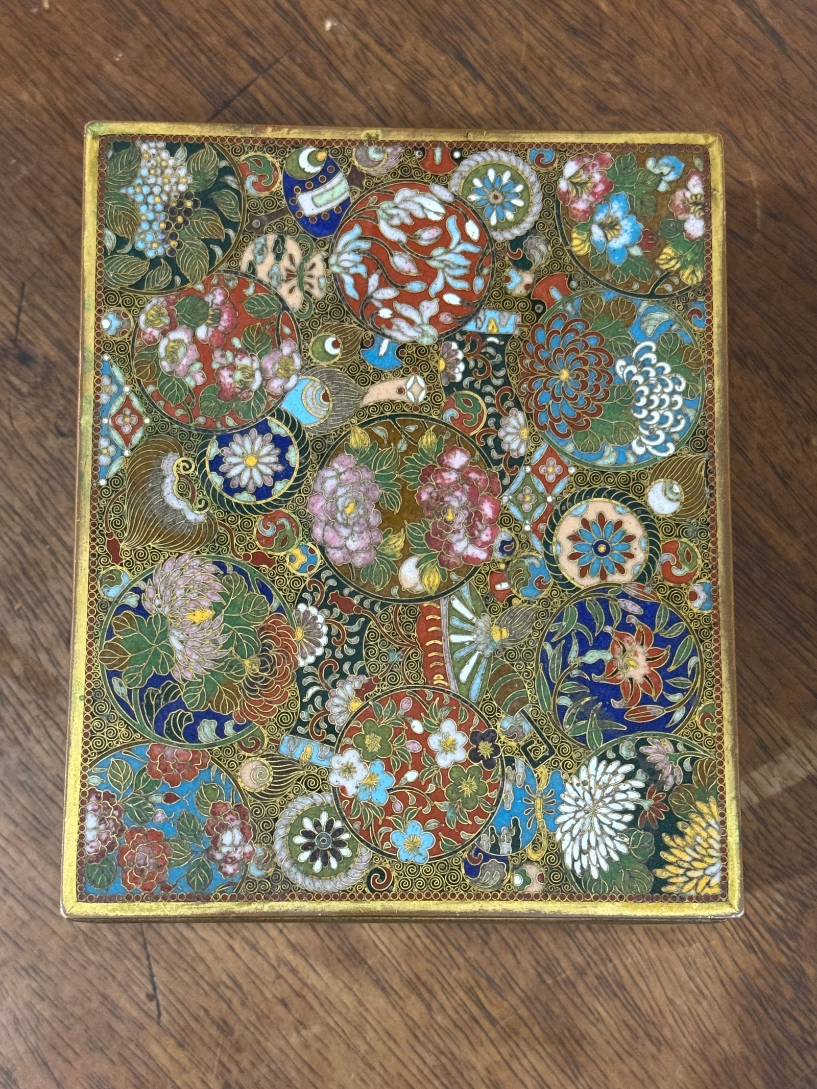 Fine Meiji period school of Namikawa Yasuyuki cloissone box: Very fine Meiji period cloisonné box. School of Namikawa Yasuyuki. enamel inlaid box with colored rondels of varied pattern, geometric surround to sides, butterfly on decorated base, raised on shaped