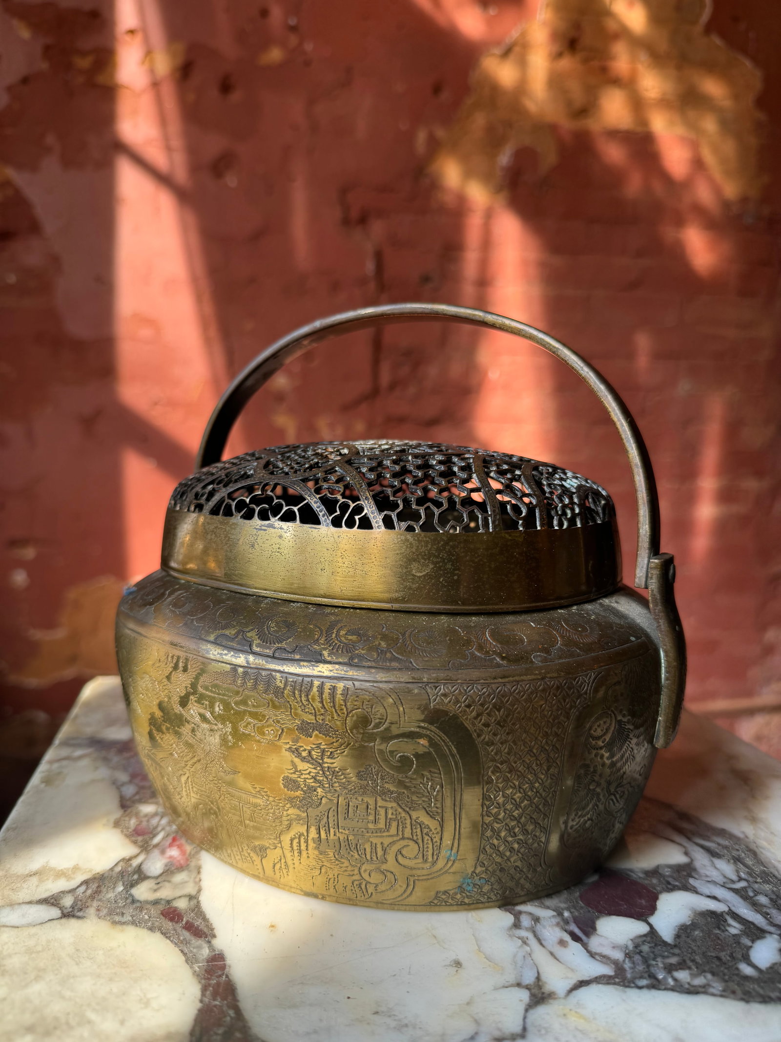 Qing dynasty Chinese gilt bronze Hand Warmer: Fine Chinese gilt bronze Hand Warmer. Beautiful pierced work vented lid. With elaborate chased scenes of Chinese landscape with Pagotto. A very fine example.The hand warmer measures at approximately 8
