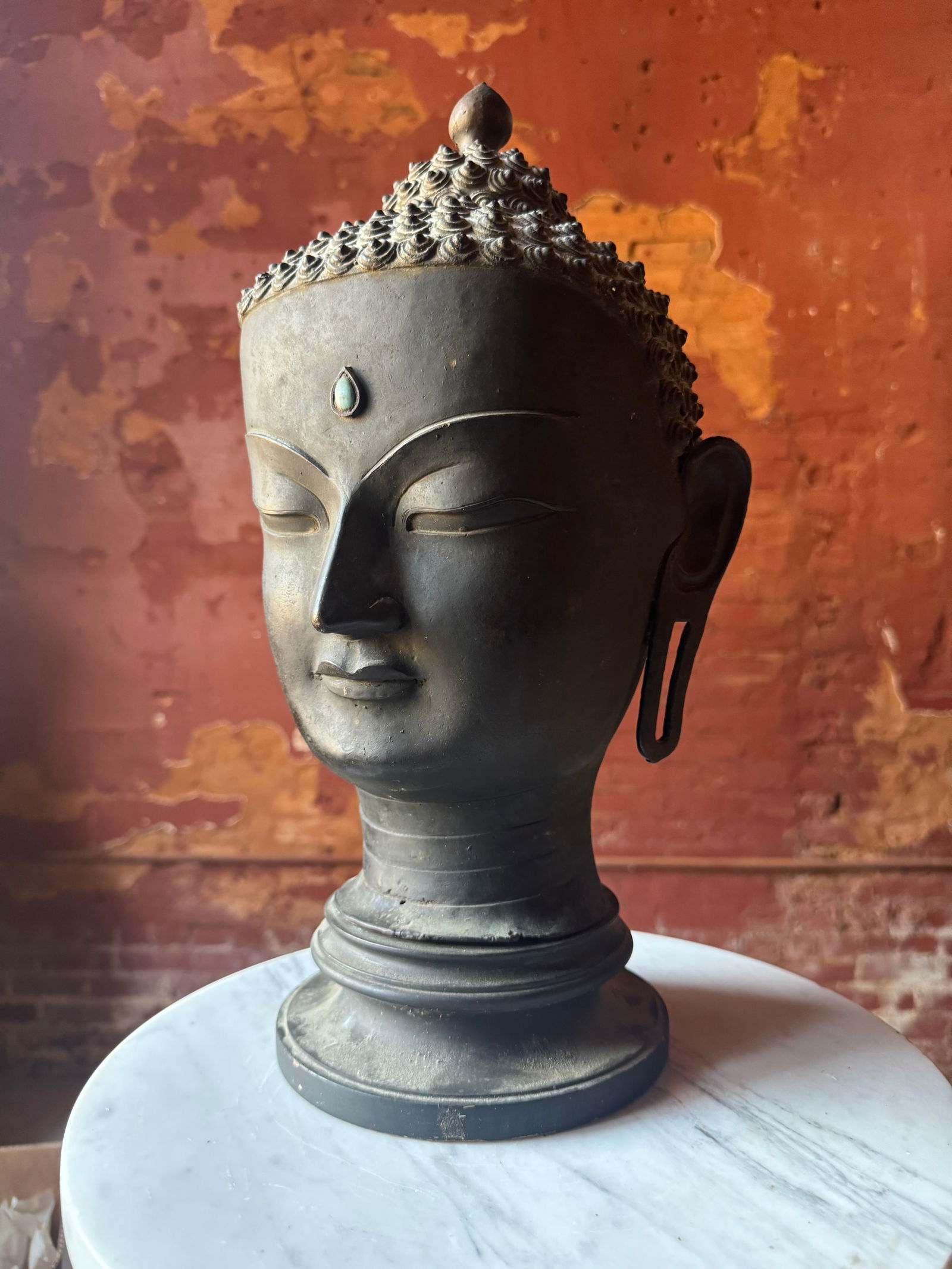 Fine Qing dynasty Bronze Buddha Head: Monumental Qing dynasty bronze Buddha head w/ inset turquoise, jewel. Beautifully cast. Prominent New York City Estate. overall height approximately 18 inches.