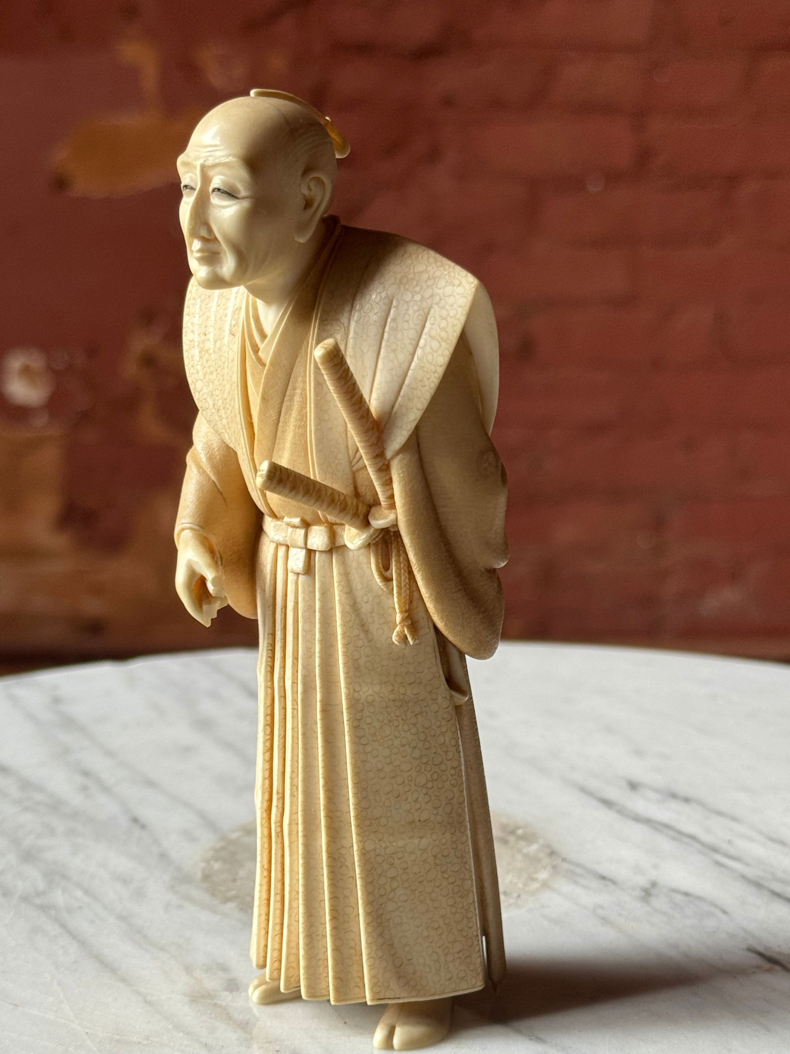 Fine Okimono Carved Figure Meiji Period 19th century: Masterwork level carved Okimono figure of a wise samurai. Meiji period. Sign within a lacquer plaque. A true gem of a sculpture. From the prominent USN collection acquired in the 1920s or 30s