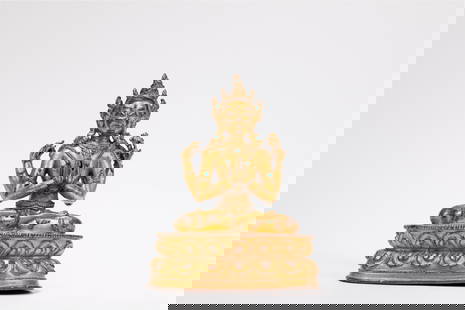A GILT-BRONZE FIGURE OF AVALOKITESVARA, Tibet, 17th / 18th century: Here he is depicted with four harms, seated on a double lotus base, with the legs in the lotus position (padmasana), the main hands are joined in the gesture of respect or greeting (anjalimudra), whil