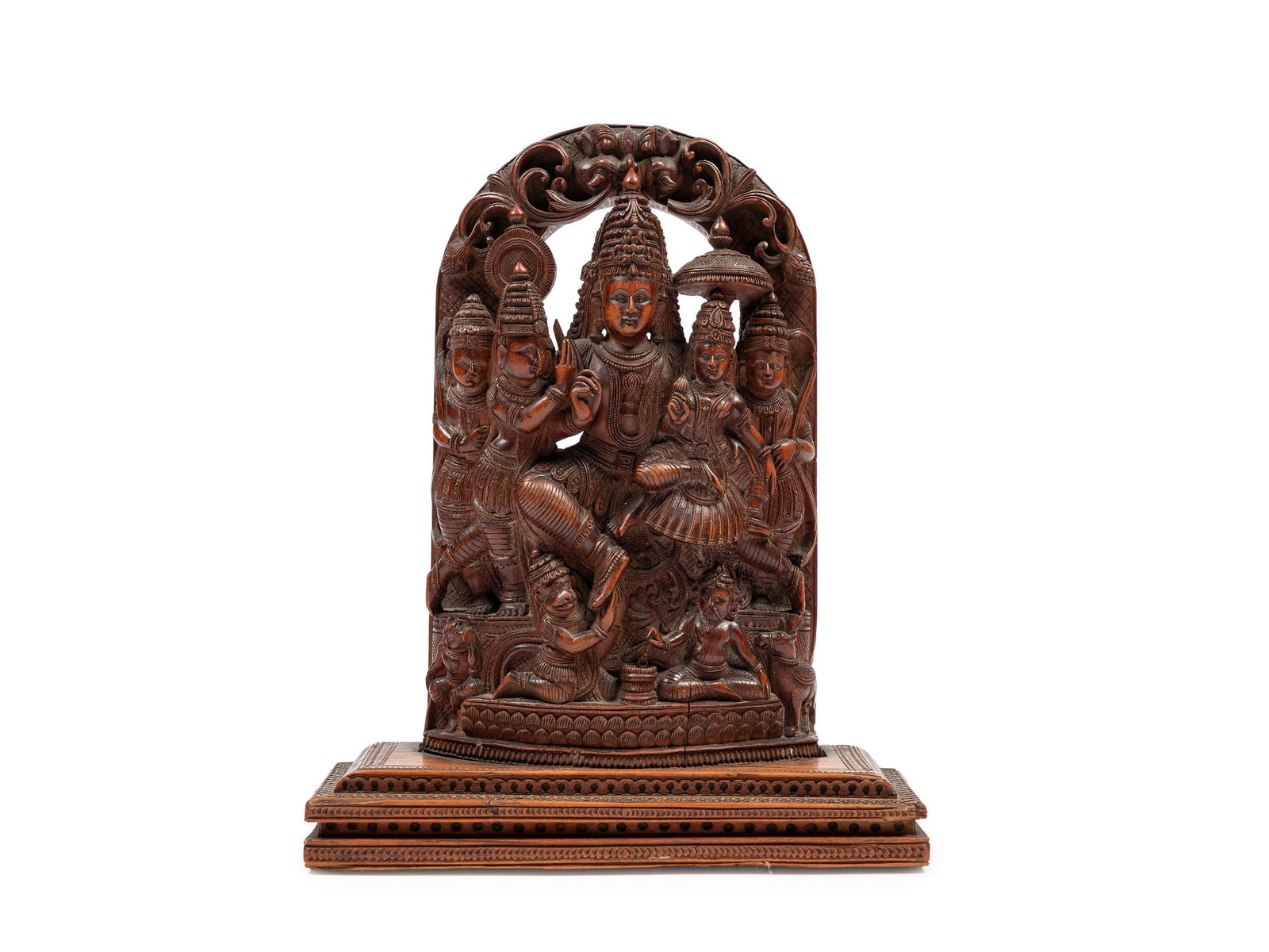 A WOODEN SCULPTURAL GROUP India, 19th / 20th century: h cm 20 Depicting Vishnu and his attendants on a finely carved throne, surmounted by the face of Garuda.