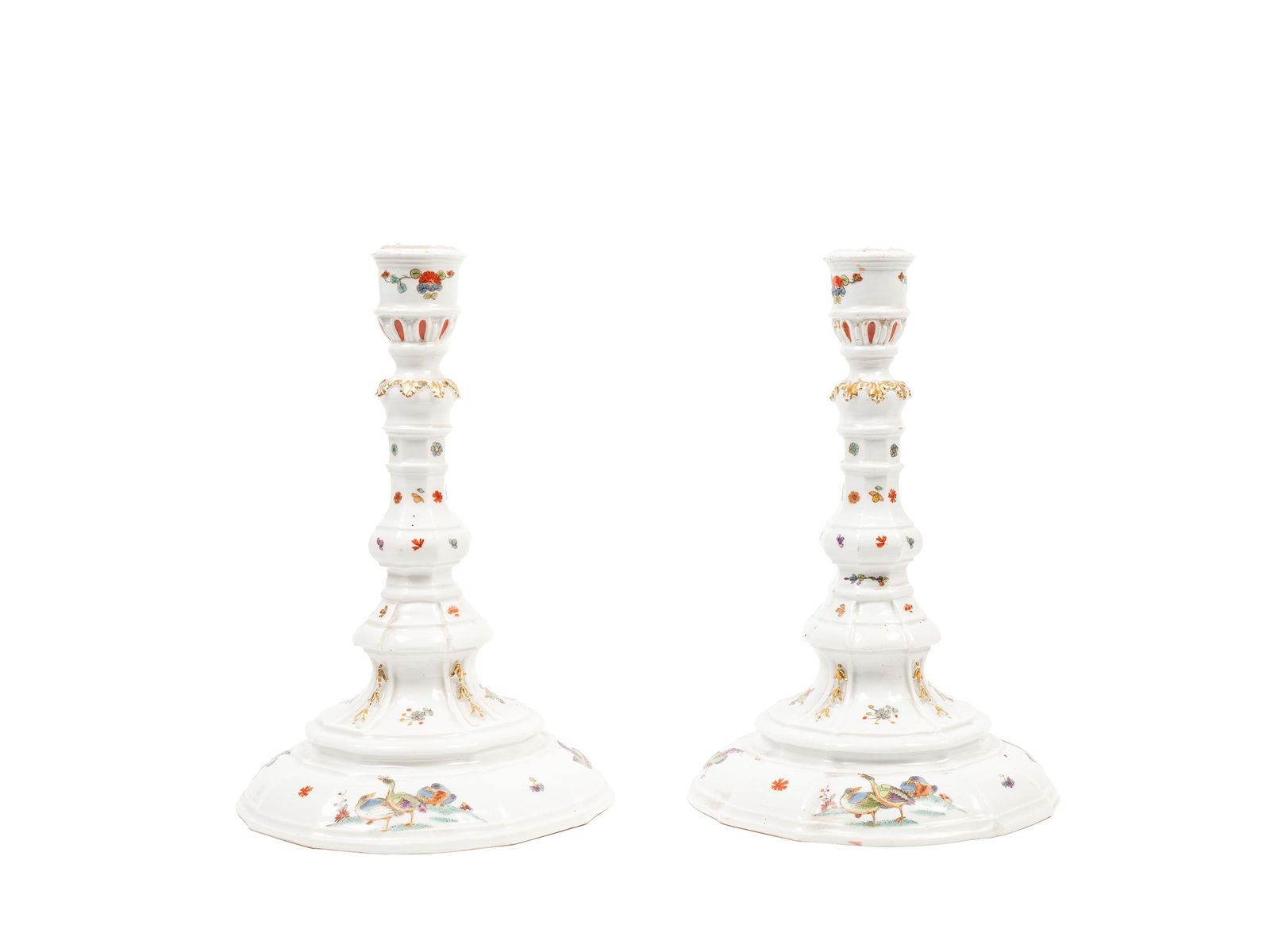 A PAIR OF MEISSEN CANDLESTICKS, 18th century: The larger h cm 24,3 x d cm 16Each with a faceted and knopped stem painted with Kakiemon-style flowers; the domed bases decorated with ducks in a floral landscape. Dreher's mark of four incised dots.