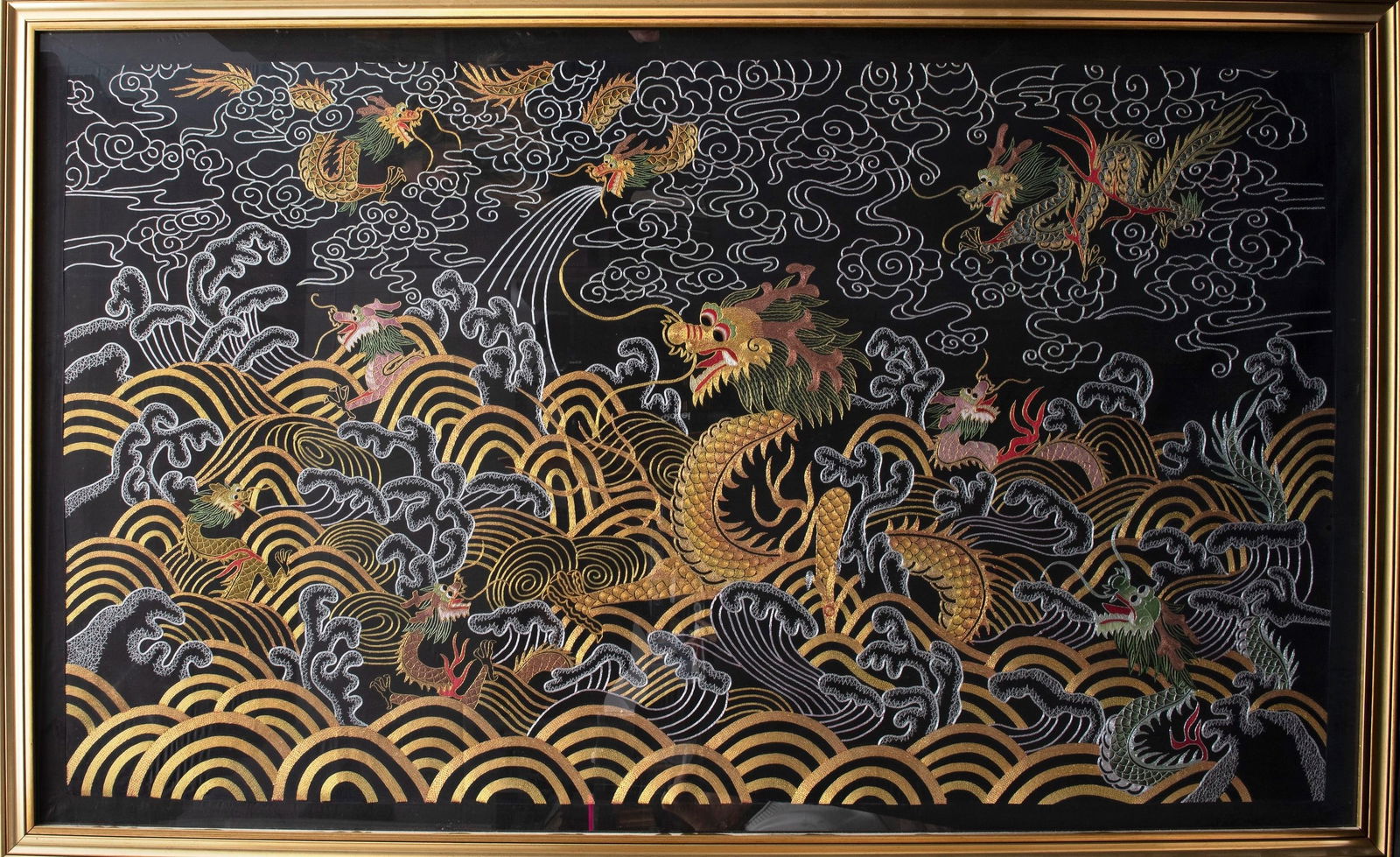 A LARGE FABRIC WITH DRAGONS, China, 20th century: h cm 97 x l cm 163With gold decorations: clouds, waves, and small dragons.