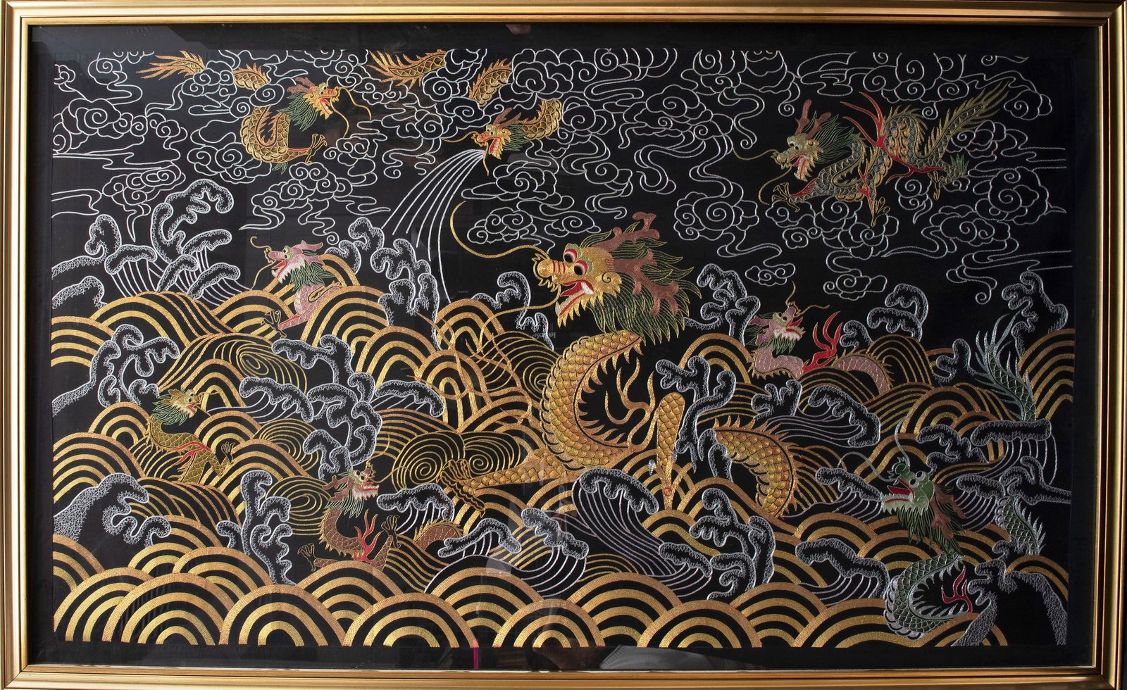 A LARGE FABRIC WITH DRAGONS, China, 20th century: h cm 97 x l cm 163 With gold decorations: clouds, waves, and small dragons.
