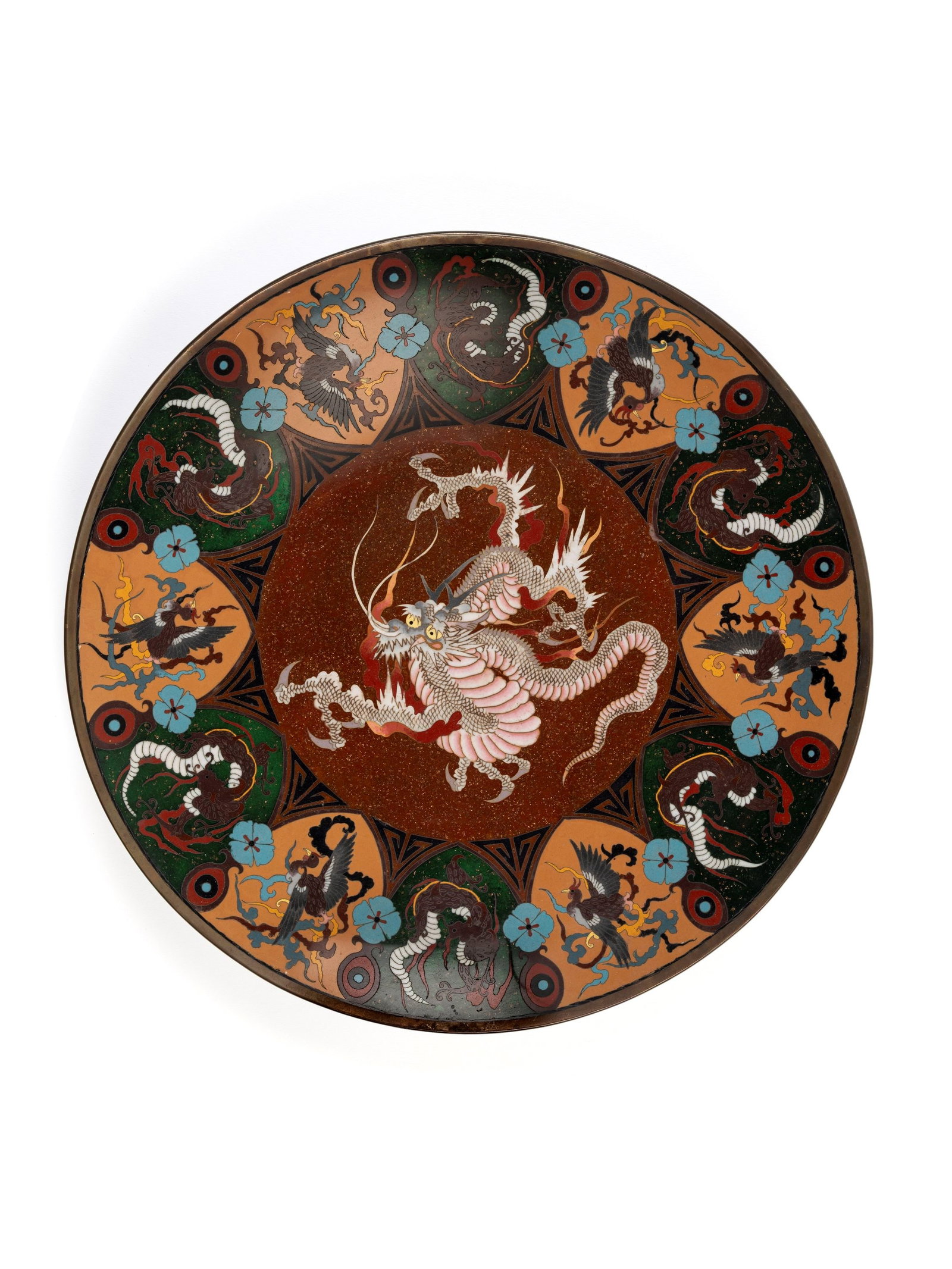 A CLOISONNÉ DISH, Japan, Meiji period (1868-1912): d cm 36 Centered with a three-clawed coiled dragon on a brown ground, the rim decorated with alternating panels depicting dragons and phoenixes.