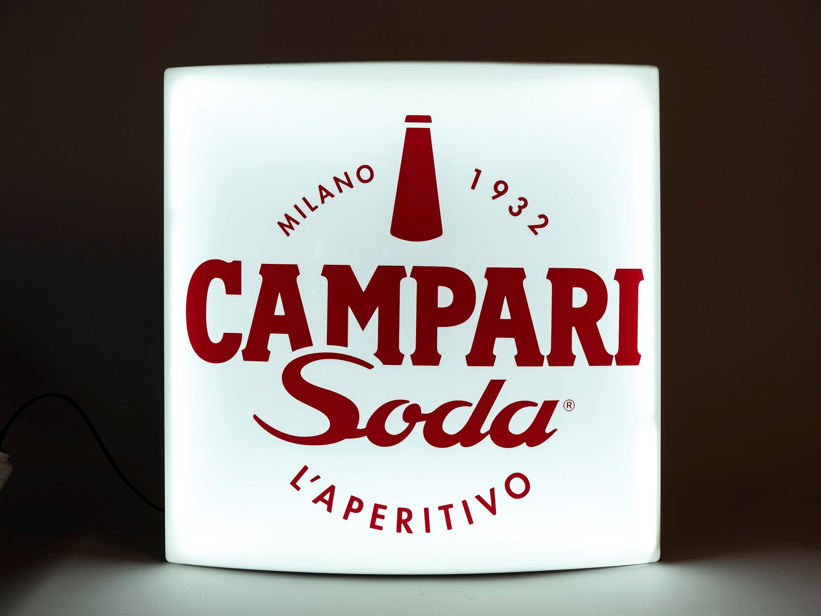 A CAMPARI SODA LIGHTED ADVERTISING SIGNBOARD “L’APERITIVO?? MILAN 1932,: h cm 70 x l cm 65 Fully functional. Made of plexiglass.