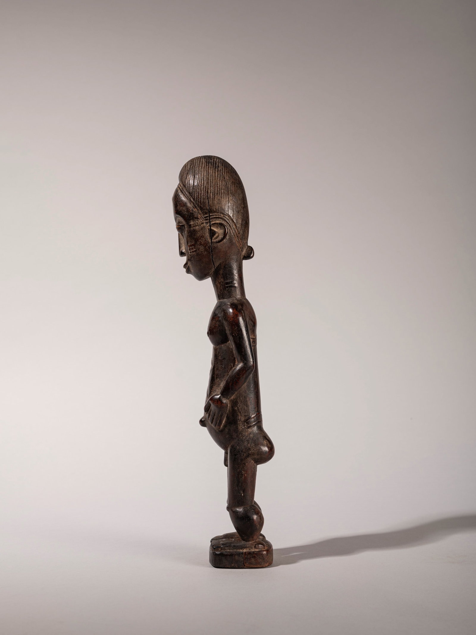 FEMALE FIGURE, Baule, Ivory Coast, mid-20th century: h cm 31 In hardwood.