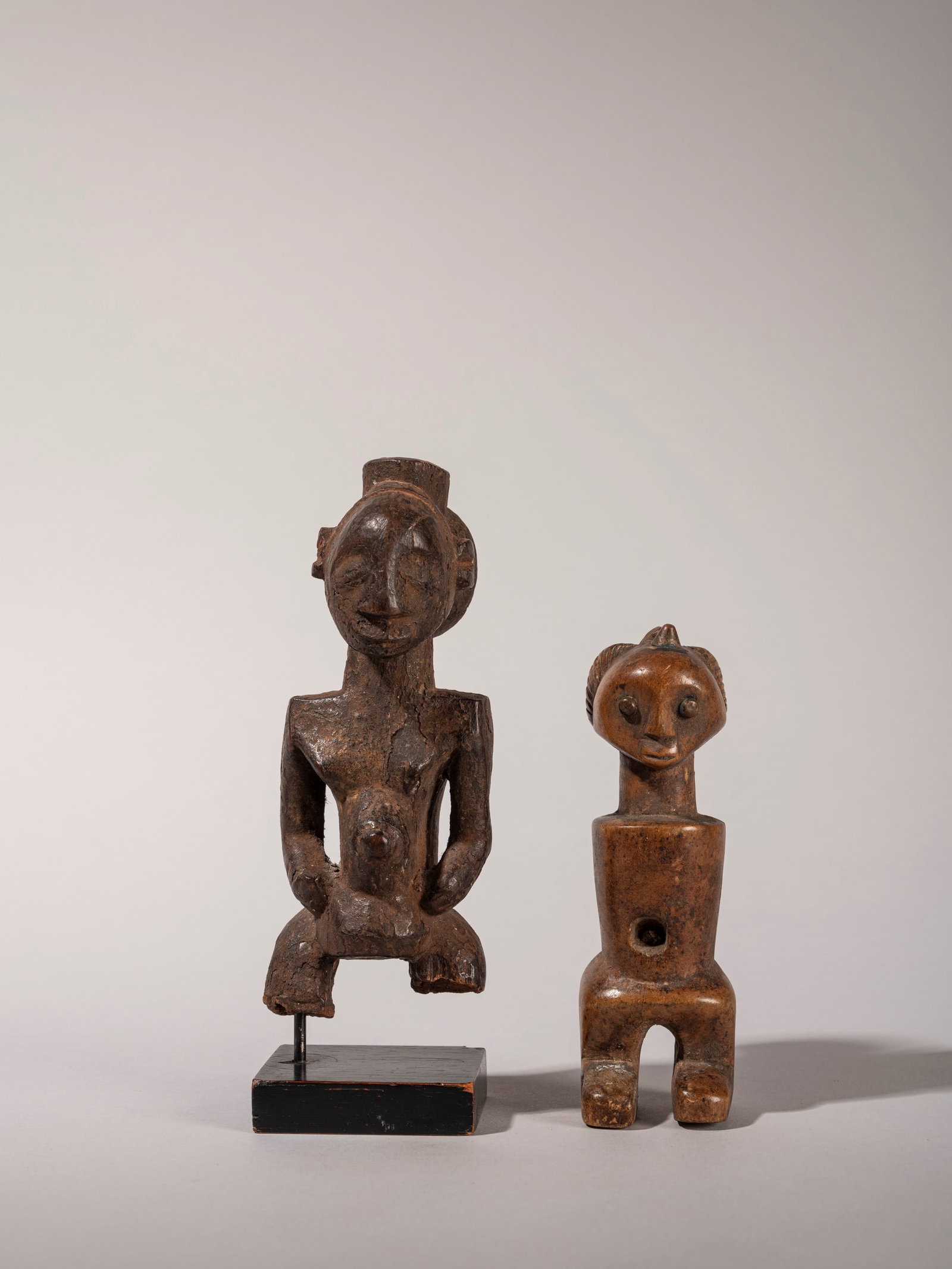 LOT COMPRISING TWO FIGURES, Lunda, Republic of the Congo: h max cm 16 The smaller one depicts a Songye fetish, the larger one a male figure