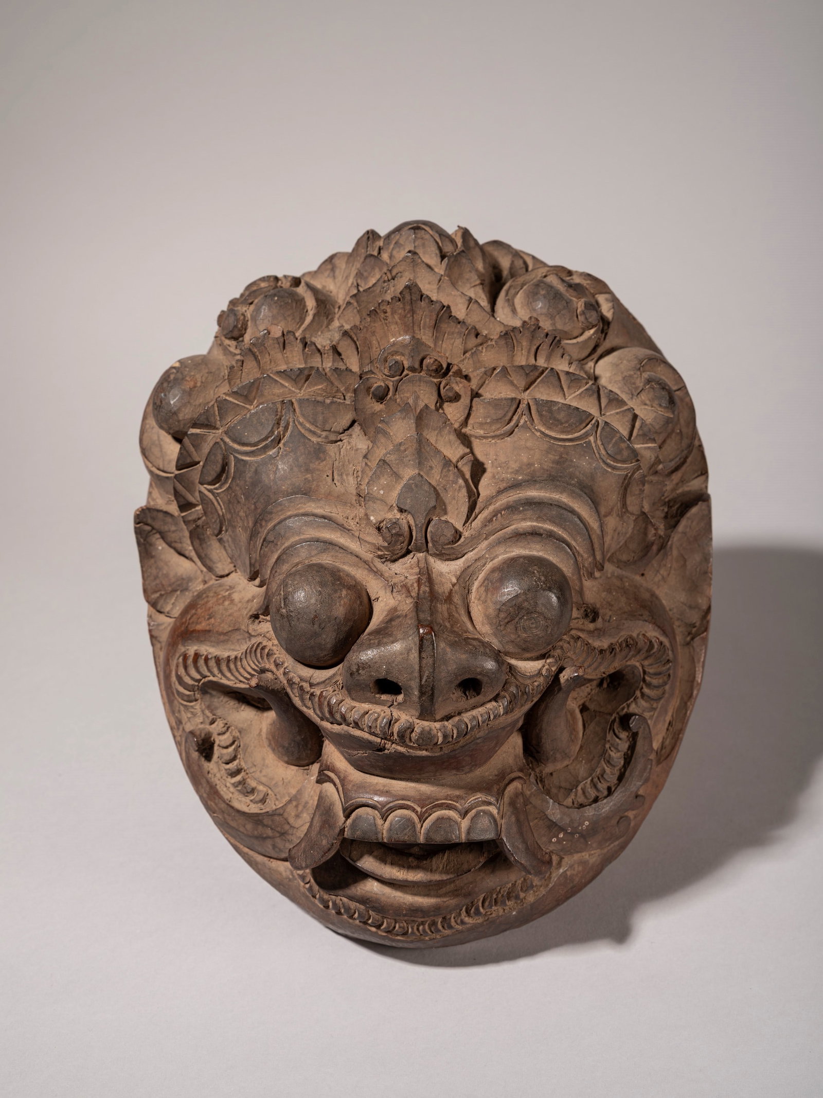 HEAVY WOODEN FRIEZE DEPICTING A DEMON, Bali, 20th century: l cm 22 x h cm 26 traditionally situated on the ceremonial tower