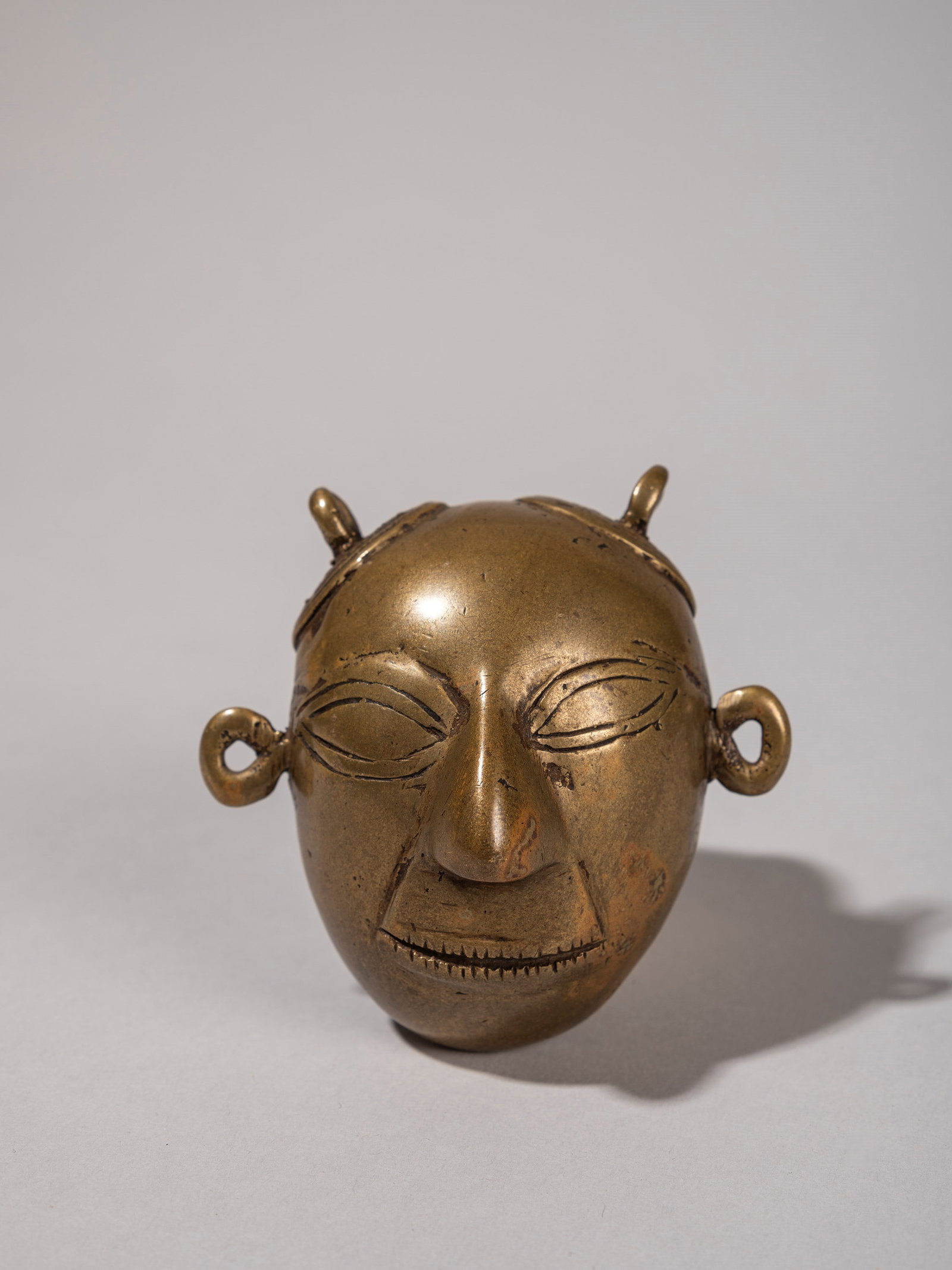 A LARGE BRONZE PENDANT, Naga, Nagaland (1 of 2)