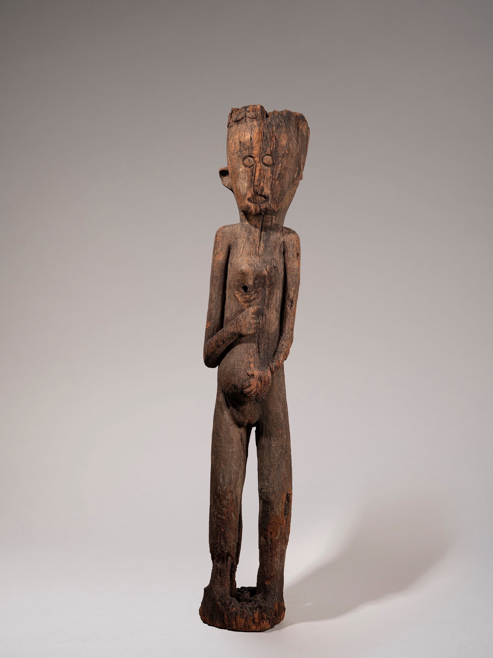 HAMPATONG, Dayak, Central Borneo, 20th century: h cm 130 Depicting a pregnant woman standing, with her hand resting on her belly; a talisman traditionally placed in the House of Ceremonies.