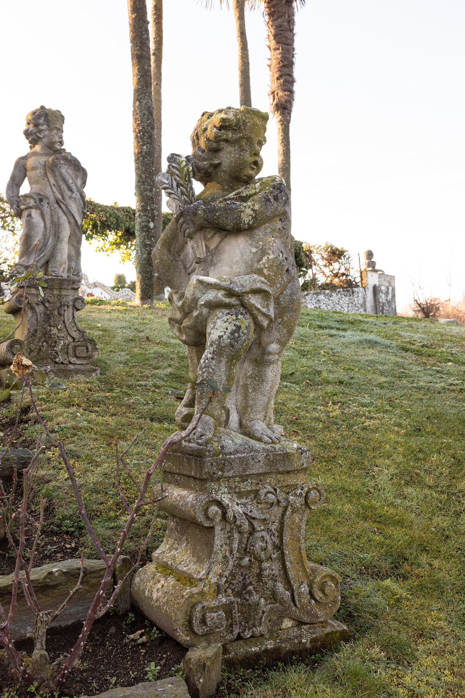 §FOUR VICENZA STONE SCULPTURES DEPICTING PUTTI, 19th century: h cm 100 (h cm 145 with base) Each putto is depicted with distinct clothing and attributes, representing allegories of the Four Seasons.This lot will not be on public view during the exhibition. Pleas