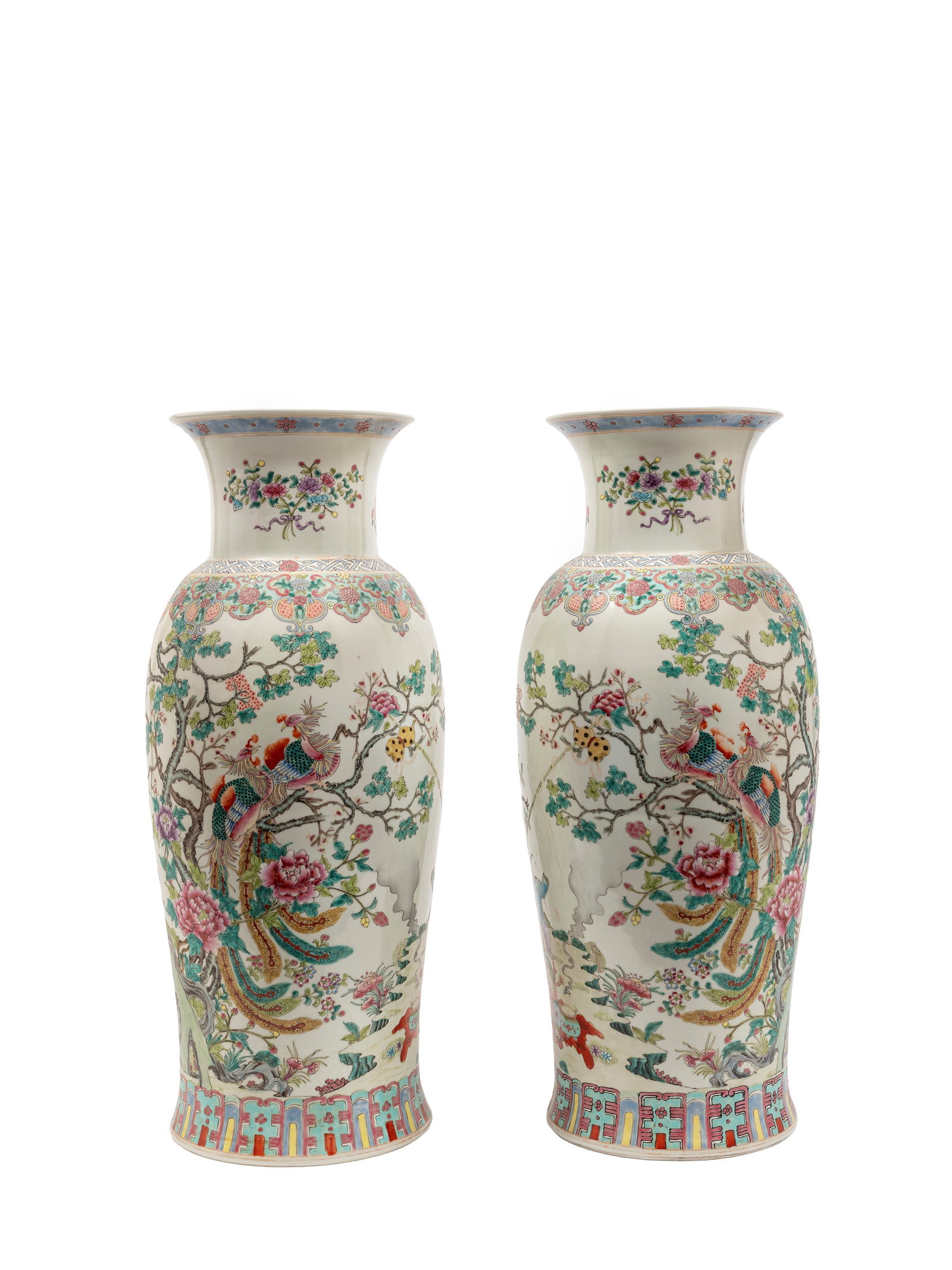 A PAIR OF LARGE FAMILLE ROSE PORCELAIN VASES, China, 20th century: h cm 61 Of baluster column form, they are painted continuously around the body with peacocks among flowering trees with peonies and lotus flowers. the base bears an apocryphal six-character mark of th