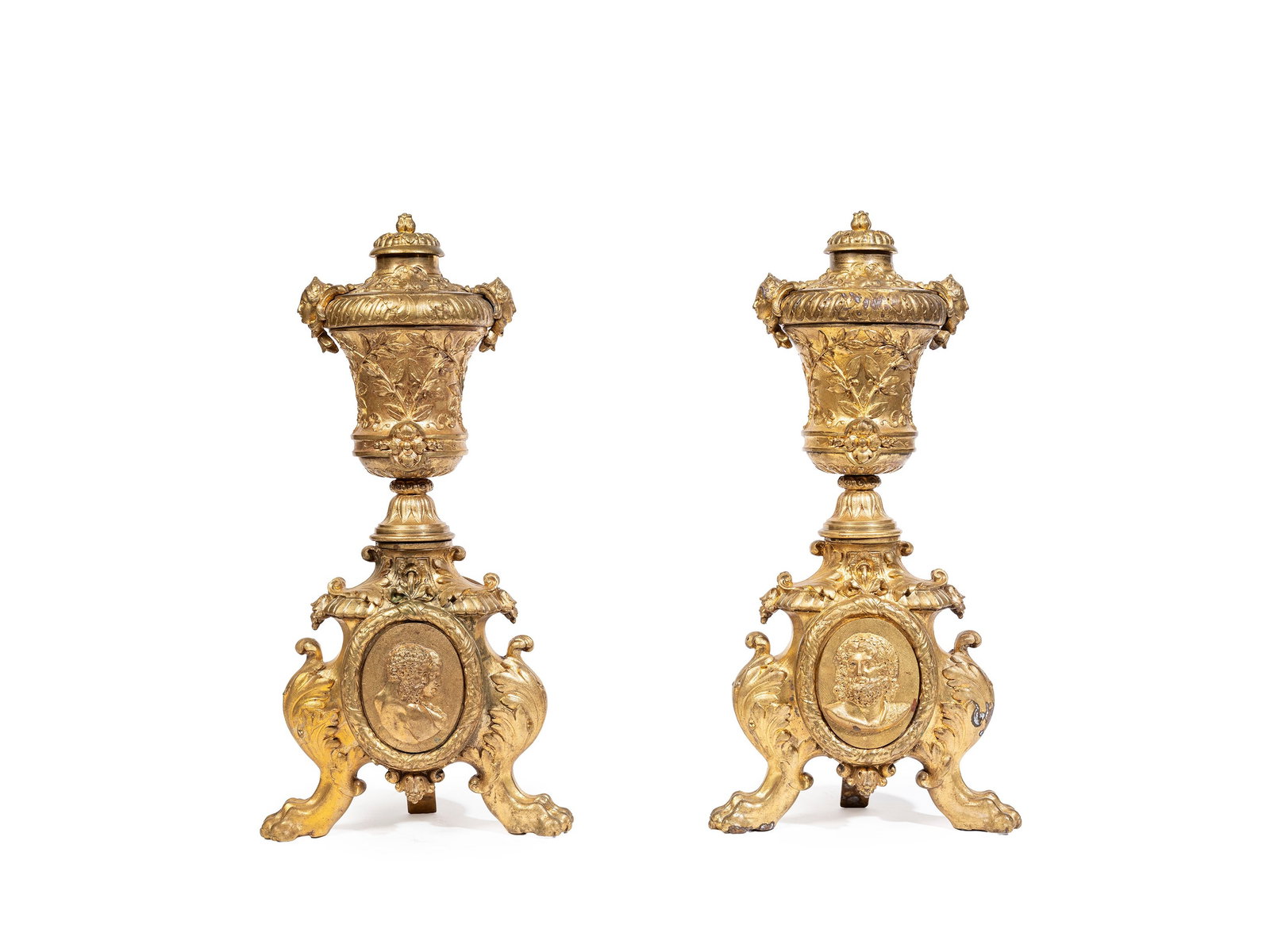 A PAIR OF GILT BRONZE ANDIRONS, France, 19th century: h cm 41,5 The upper part is surmounted by urns decorated with festoons, fluting and flame finials; the bases include a central medallion depicting classical profiles.