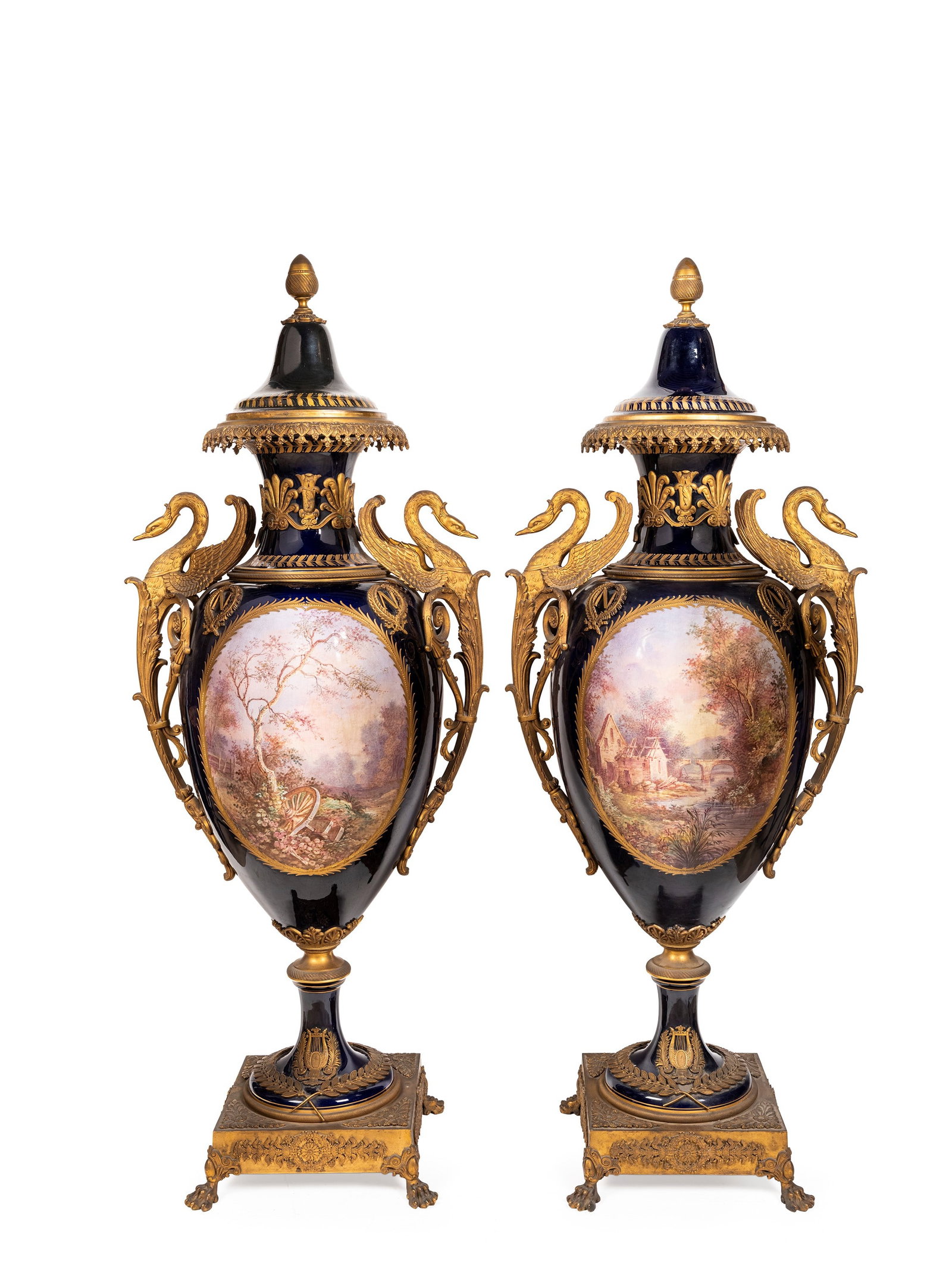 PAIR OF LARGE COBALT-BLUE PORCELAIN VASES MOUNTED IN FINELY CHASED AND GILT BRONZE, France, late: h cm 114 The ovoid bodies are decorated on one side with scenes from the Napoleonic campaigns and on the other with bucolic landscapes, signed Poitevin. The gilt-bronze handles are shaped as winged sw
