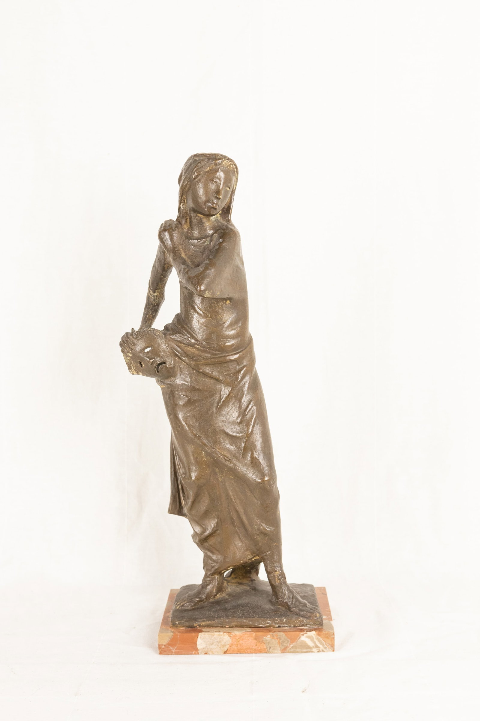 °A BRONZE SCULPTURE DEPICTING “ALLEGORY OF THE THEATRE??, 1938 ca: h cm 43 x l cm 15 x p cm 13 Signed on the base a. biggi. the sculpture is a clear representation of the figure of classical tragedy, a woman dressed in ancient style with a peplos holding a mask in he