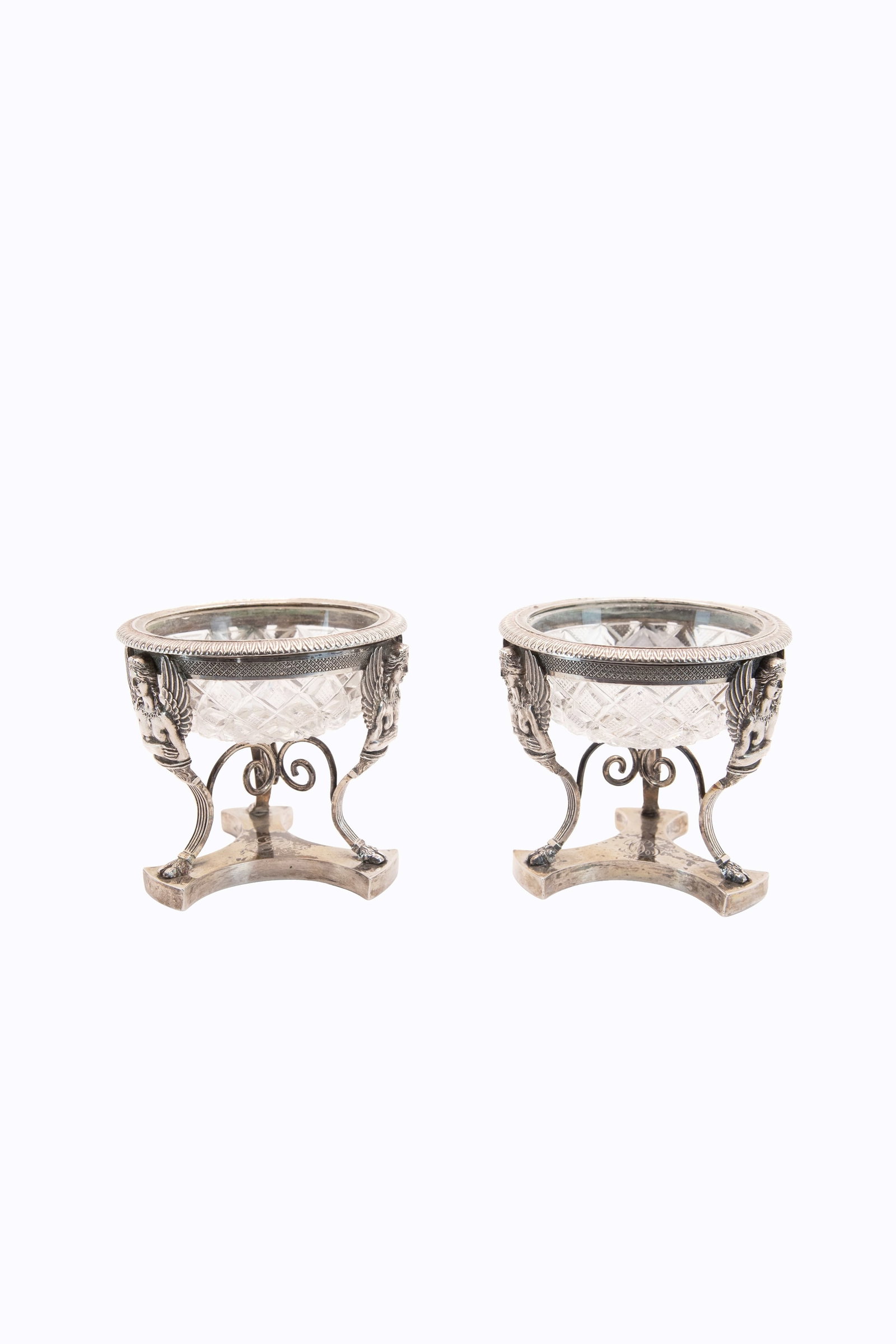 °PAIR OF SILVER AND CRYSTAL SALT CELLARS, Milan, 19th century.: h cm 7 x d cm 7,6 (each) Tripod-shaped, decorated with winged caryatids. Lombardo-Veneto hallmark under the base.
