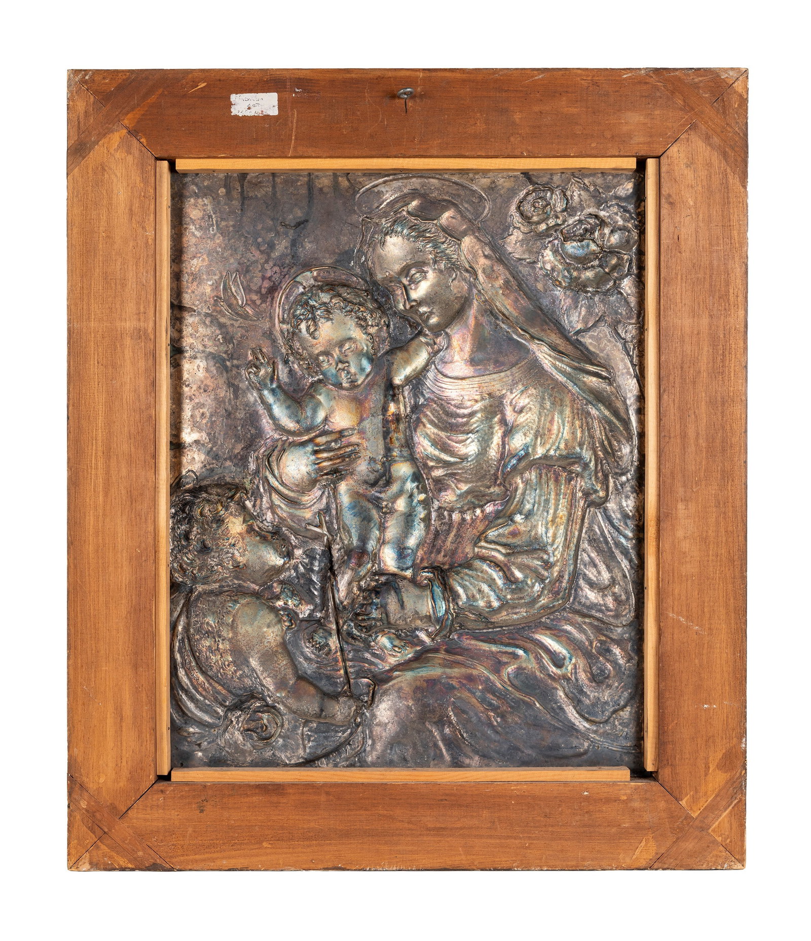 A SILVER PLAQUE WITH HIGH RELIEF, Italy, 20th century: h cm 51 x l cm 41 Finely chased and embossed, it depicts a Madonna and Child with Saint John the Baptist. Signed Lorenzo Foglia at the lower right.