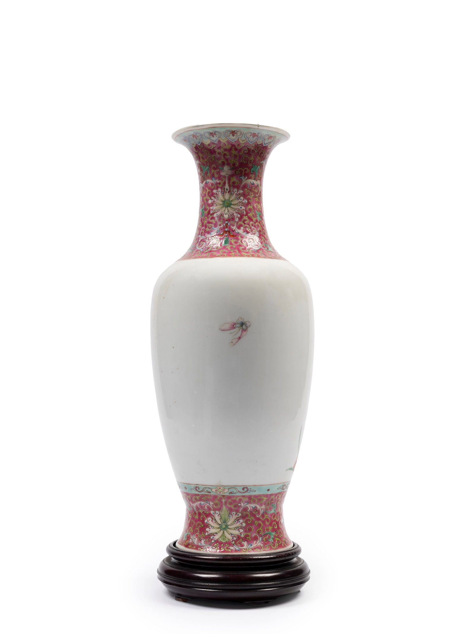 A FAMILLE ROSE BALUSTER-SHAPED PORCELAIN VASE, China, Republic Period (1912-1949): h cm 38 It depicts two birds on a peach tree in a garden among rocks and flowers. The neck and raised foot feature scrolling lotus motifs. At the center of the base, it bears the red overglaze square 