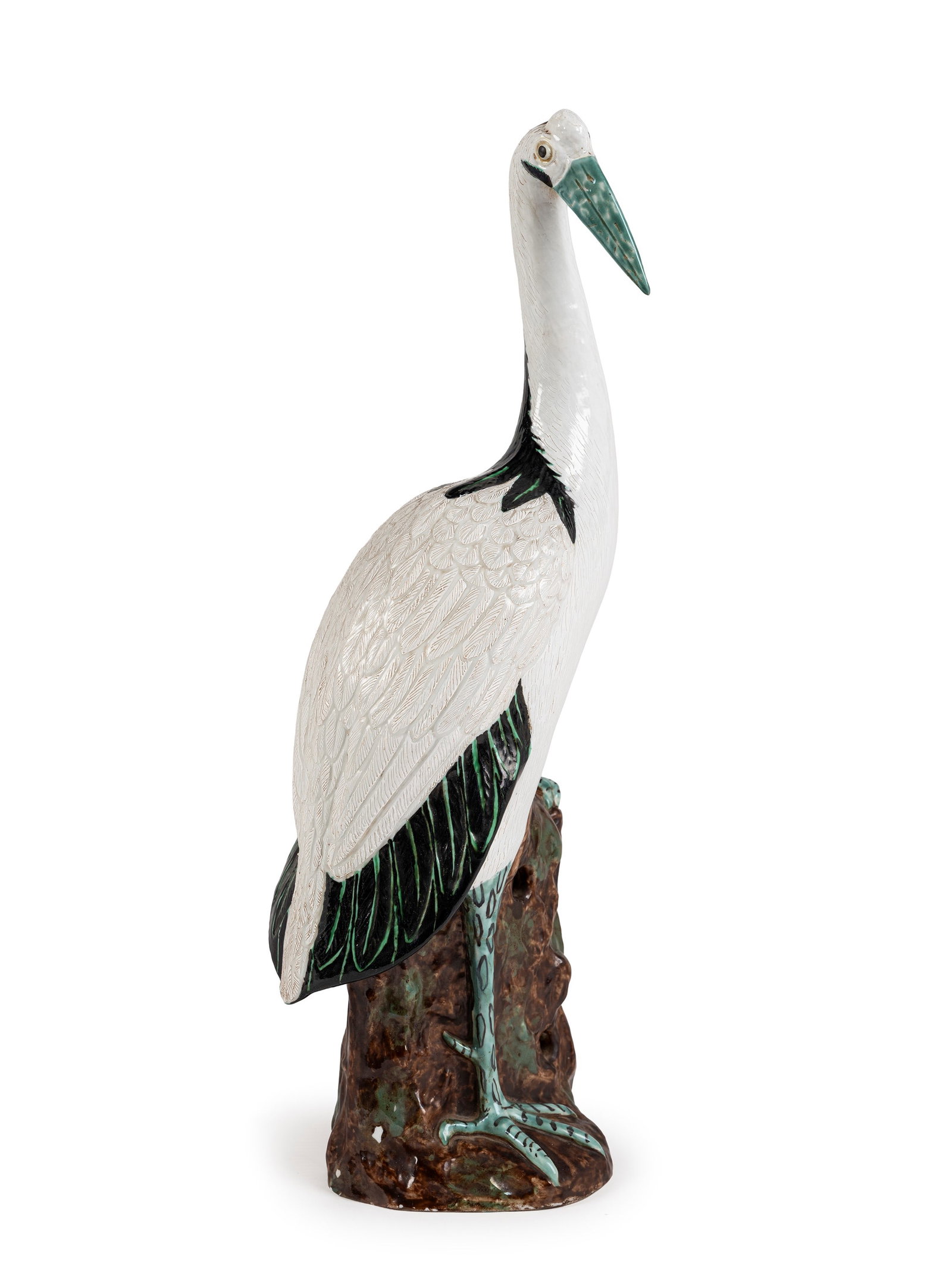 A PORCELAIN CRANE, China, 20th century: h cm 43,5 Depicted with its head tilted, perched on a dark tree stump.