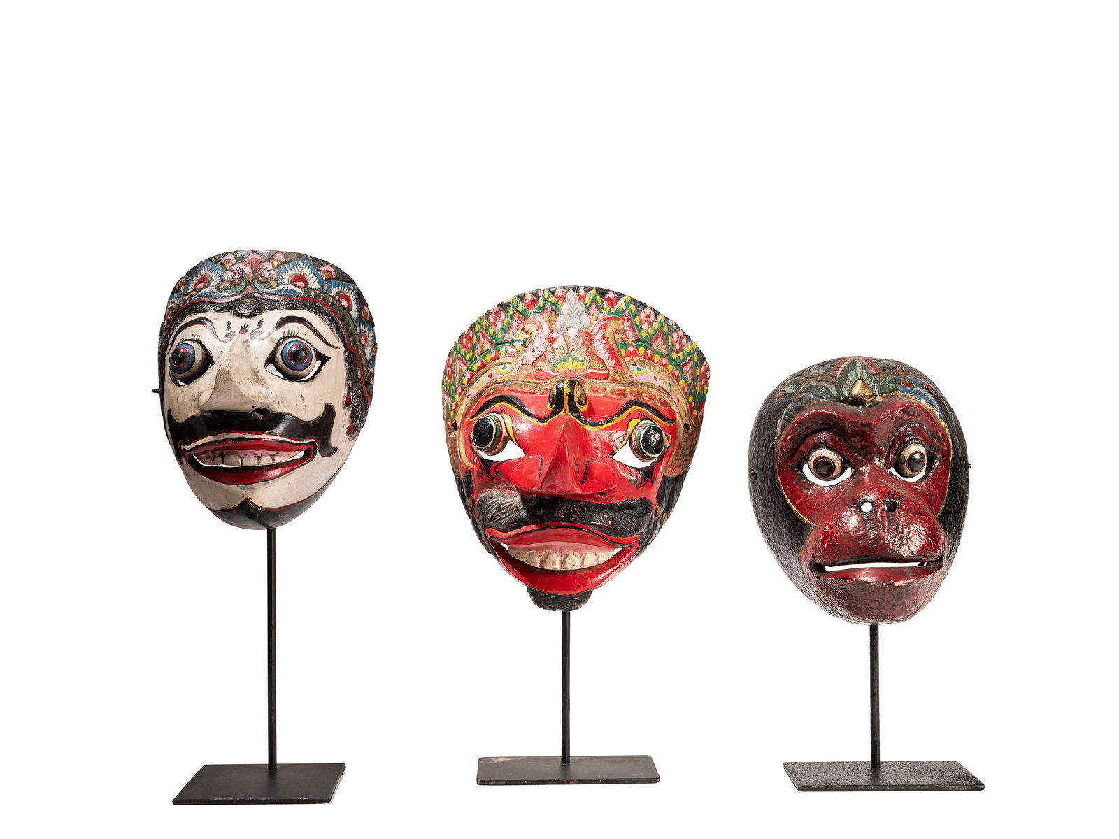 °A LOT COMPRISING THREE POLYCHROME WOOD THEATRE MASKS, Central Java: h cm 22 x l cm 20 Depicting characters from the classical epic poem the Ramayana.