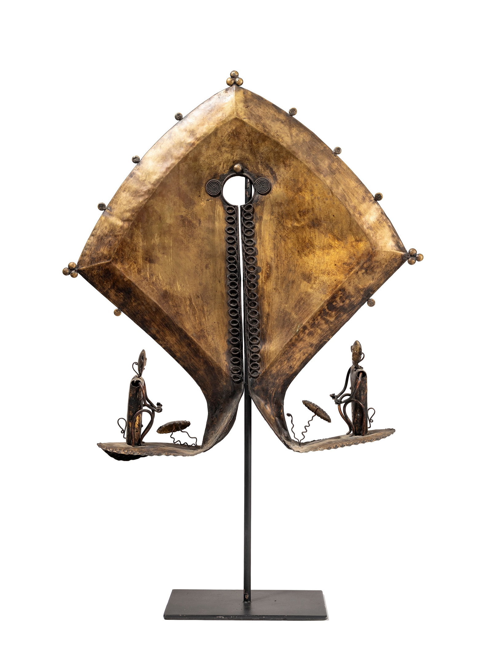 °A LARGE AMULET (MAMULI), Sumba Island, Eastern Indonesia.: h cm 40 x l cm 40 In repoussé copper with anthropomorphic figures and spiral relief appliqués.