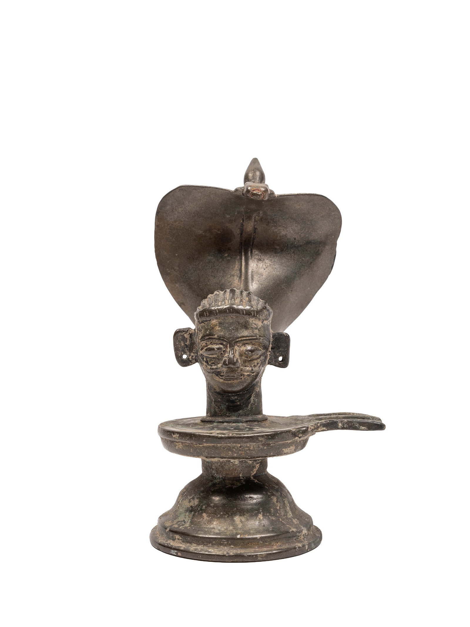 A YONI LINGAM, India, 19th century: h cm 19 On a circular base, with the head of Shiva on a yoni platform.