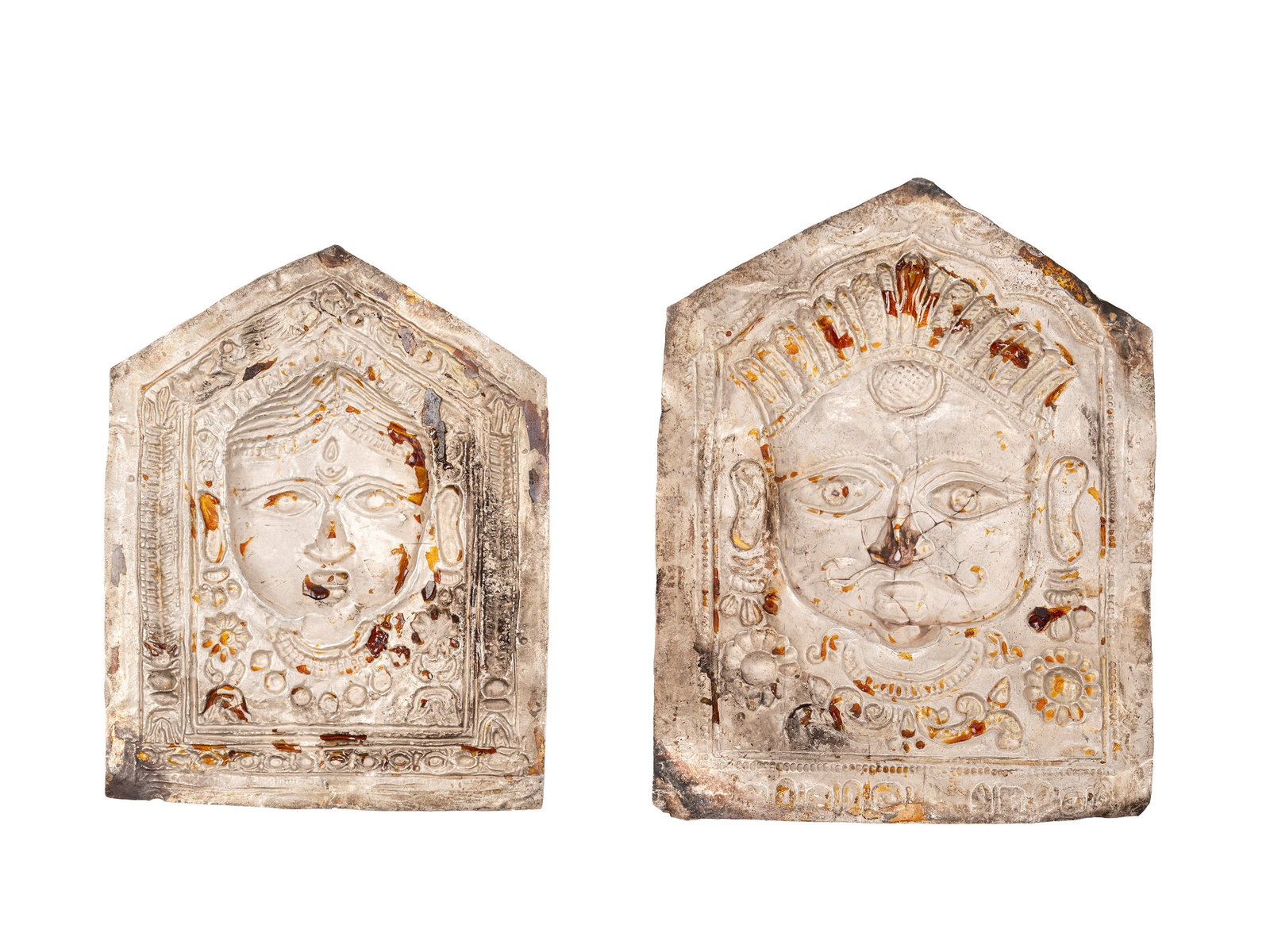 A PAIR OF SILVER TEMPLE OFFERING MASKS, India, 19th century: the largest h cm 11.3 Both made of silver sheet, repoussé and hand-chased, the sheets originate from Himachal Pradesh, specifically the Kulu region, in India. The faces identify deities from the Hind