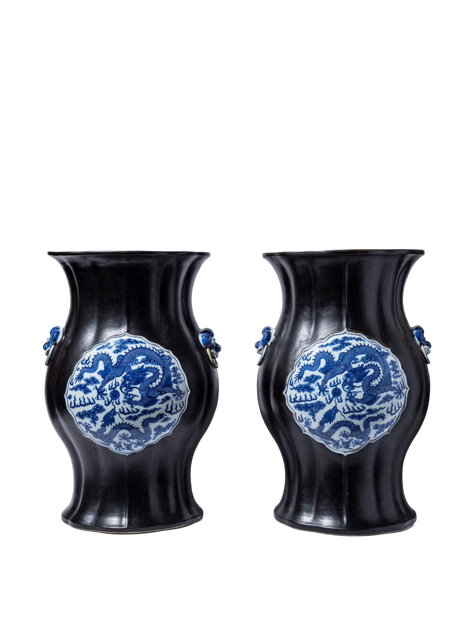 A RARE AND IMPORTANT PAIR OF IMPERIAL BLACK-GROUND BLUE AND WHITE PORCELAIN VASES, China, Qing: h cm 105Of sinuous form, the body rises to a broad rounded shoulder and tapers to a flaring neck with everted rim, finely painted with gilt-edged medallions enclosing bats, flowers, qilong, fruits and