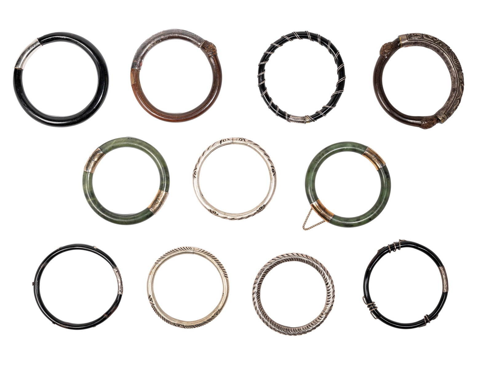 ELEVEN SILVER METAL AND HARDSTONE BANGLES, China, 20th century: d max cm 9 20世纪 民国时期的手镯十一个