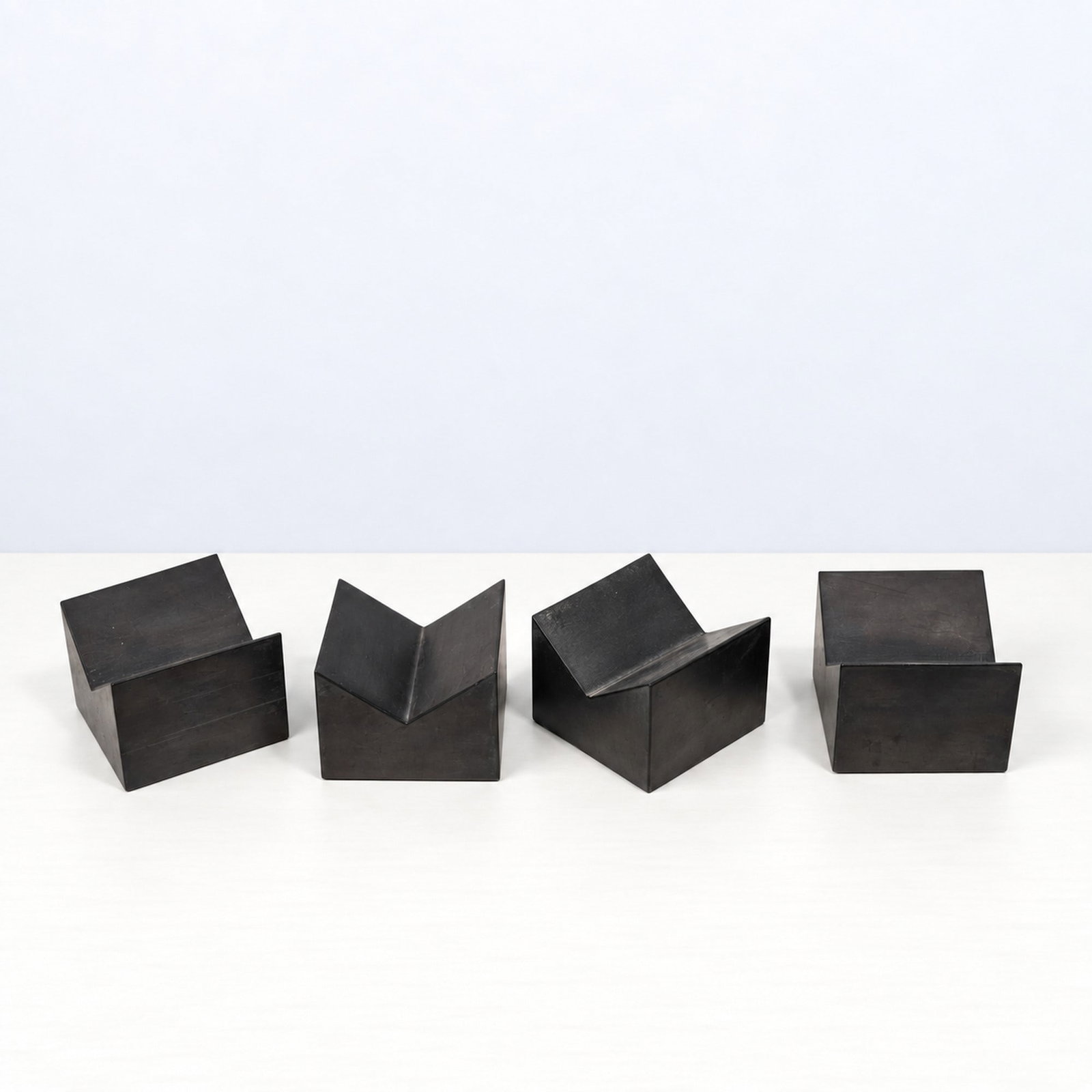Giulio Lazzotti (Pietrasanta 1943 - 2024), "PETIT GRANIT" PAPERWEIGHTS, circa 1980: h cm 6 x l cm 8 x w cm 8 Set of four. Pietra serena, Mageia production, Italy.