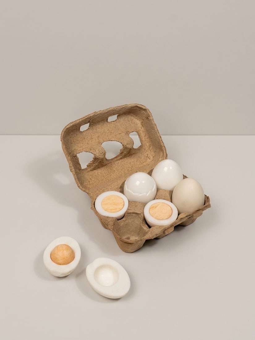 Giulio Lazzotti (Pietrasanta 1943 - 2024), "THE HARD BOILED EGG SAGA" SCULPTURE, circa 1977: h cm 9 x l cm 15 x w cm 10 Statuary marble and Mexican yellow onyx. CAMP production (Consorzio Artigiani del Marmo di Pietrasanta), Italy. Accompanied by original egg carton and brochures.
