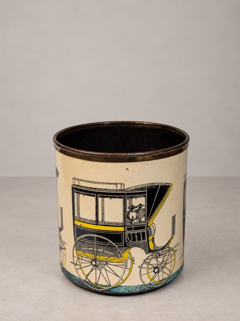 Piero Fornasetti (Milano 1913 - 1988), WASTEPAPER BIN, circa 1960s: h cm 27,5 x d cm 24 Screen-printed metal with decoration from the "Carrozze" series. Manufacturer's mark on the underside. Produced by Fornasetti, Milan, Italy.Catalogue notes: for the same decoration