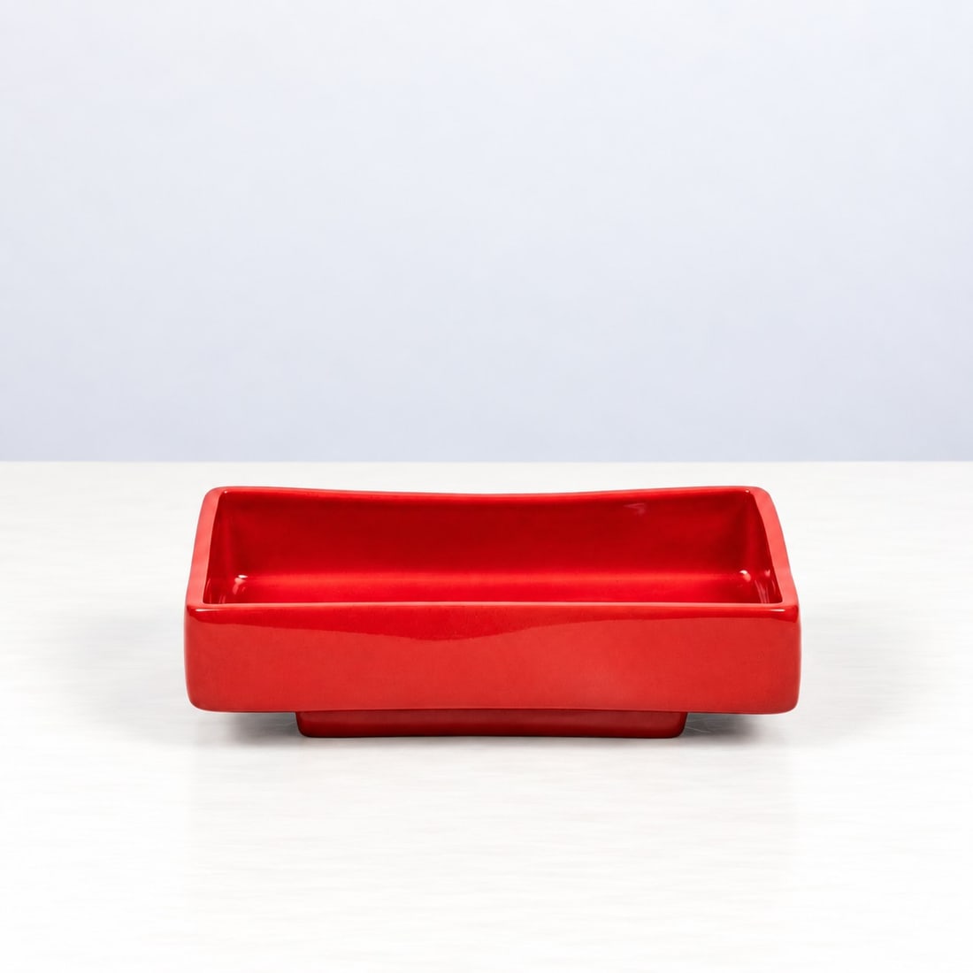 Franco Meneguzzo (Valdagno 1924 - 2008), RECTANGULAR BOWL, 1959: l cm 21 x h cm 6 x w cm 12 Glazed earthenware, on a truncated-pyramid shaped foot. Danish workshop; the manufacturer’s mark, ‘Meneguzzo’, and an initials are stamped on the reverse.Catalogue Not