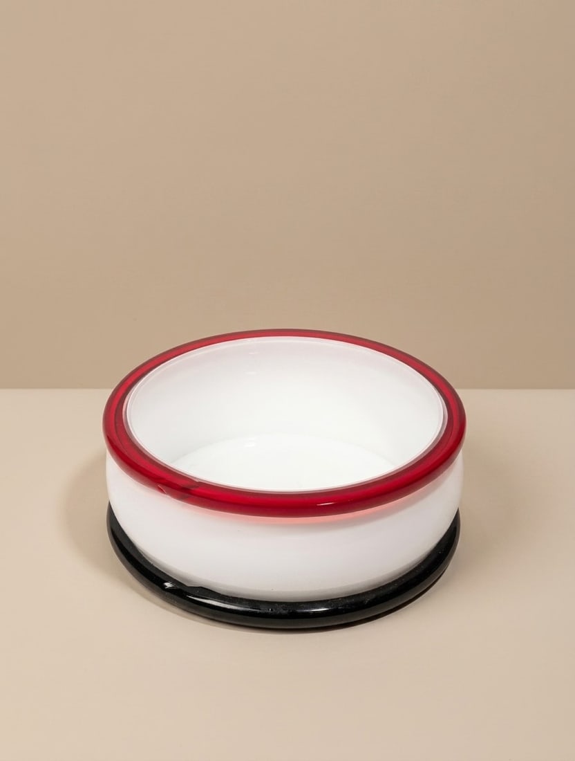 Ettore Sottsass (Innsbruck 1917 - 2007), "PALLADIA" BOWL, circa 1977: h cm 8,5 x d cm 23 Lattimo and colored incalmo Murano glass. Signed and numbered 181/250. Vistosi production, Italy.
