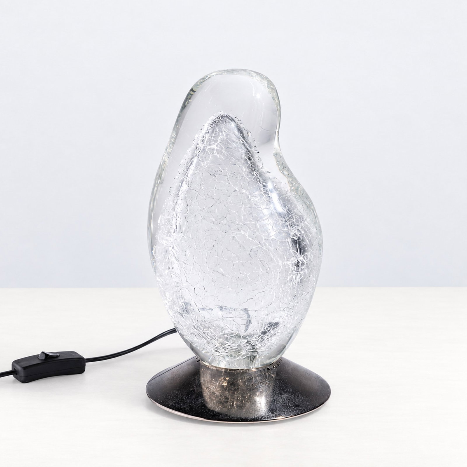 Alfredo Barbini (Venezia 1912 - Venezia 2007), "GOCCE DI LUCE" TABLE LAMP, circa 1980's: h cm 27,5 Clear Murano glass with craquelé effect and metal base. Manufacturer's and model labels to the underside. Produced by Barbini, Murano, Italy.