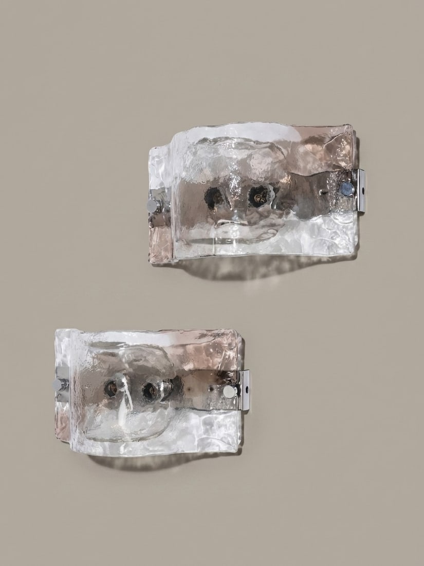 Carlo Nason (Murano 1935), WALL LIGHTS, MODEL LP276, circa 1970s: l cm 18 x h cm 34 Pair. Murano glass diffusers with relief decoration, chrome-plated metal supports. Produced by A.V. Mazzega, Italy.