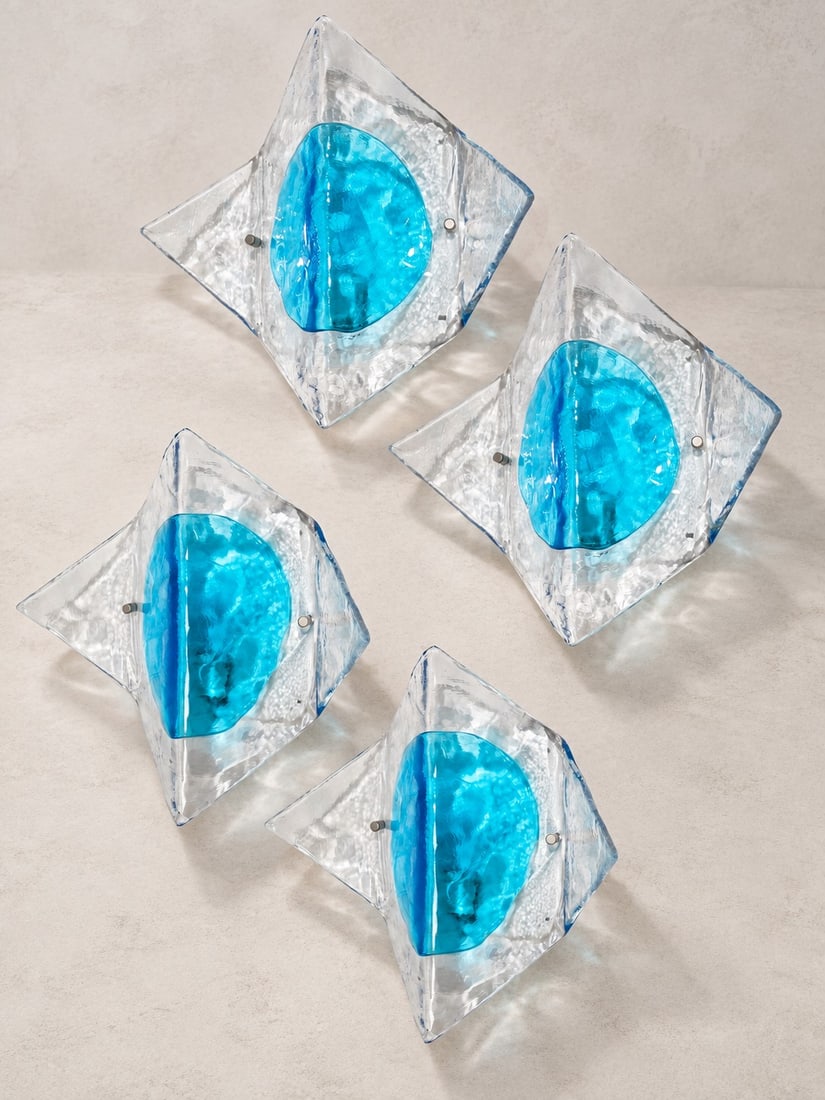 Carlo Nason (Murano 1935), WALL LIGHTS, MODEL LP253, circa 1970s: h cm 31 x l cm 31 x w cm 14 Set of four. Murano glass diffusers with a light blue polychrome insert, chrome-plated metal supports. Produced by A.V. Mazzega, Italy.
